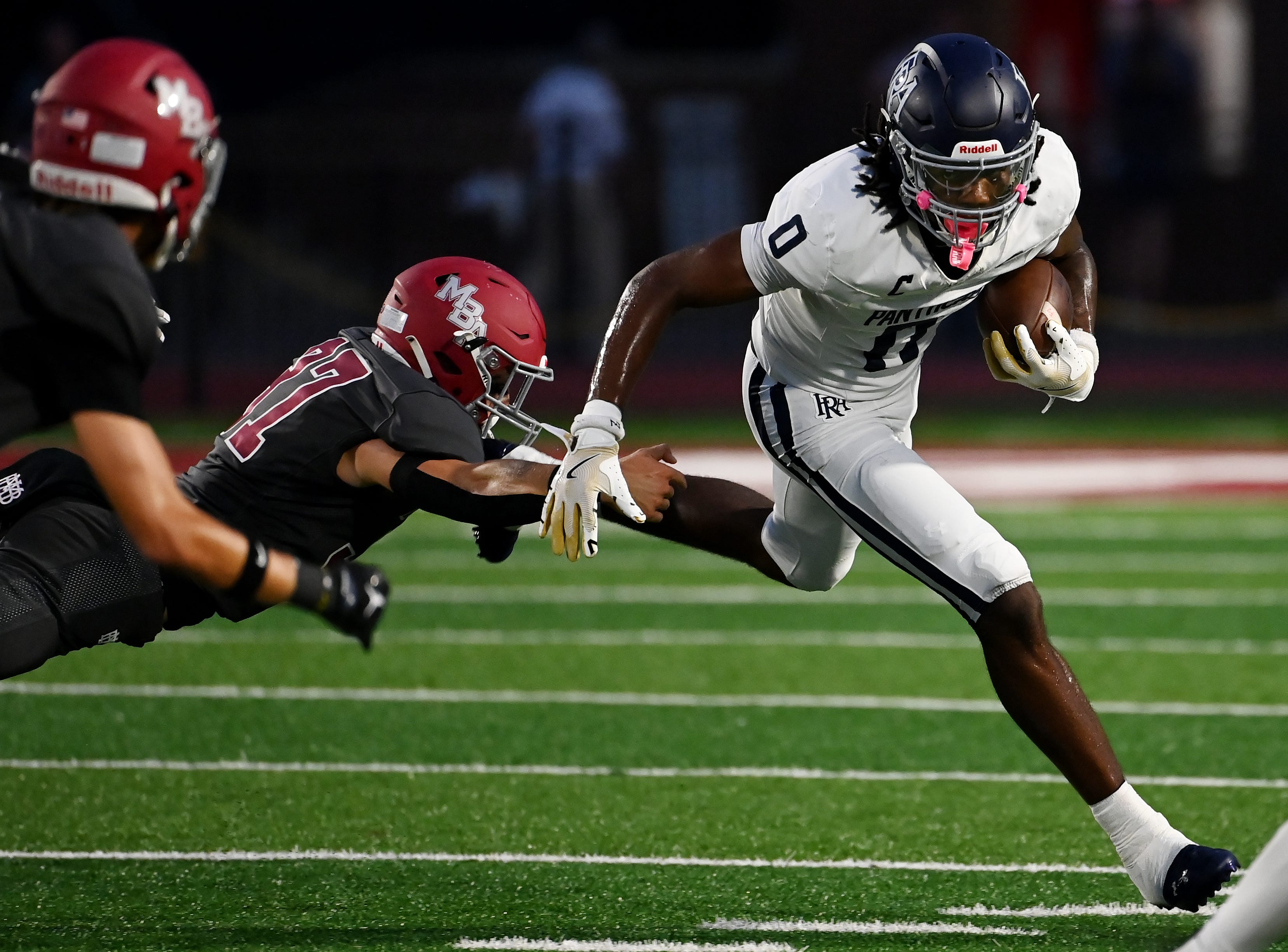 Franklin Road Academy's Omarii Sanders (0) runs around MBA’s Johnny Com (37) during a TSSAA high school football game  on Friday, Sept. 4, 2026, in Nashville, Tenn.
