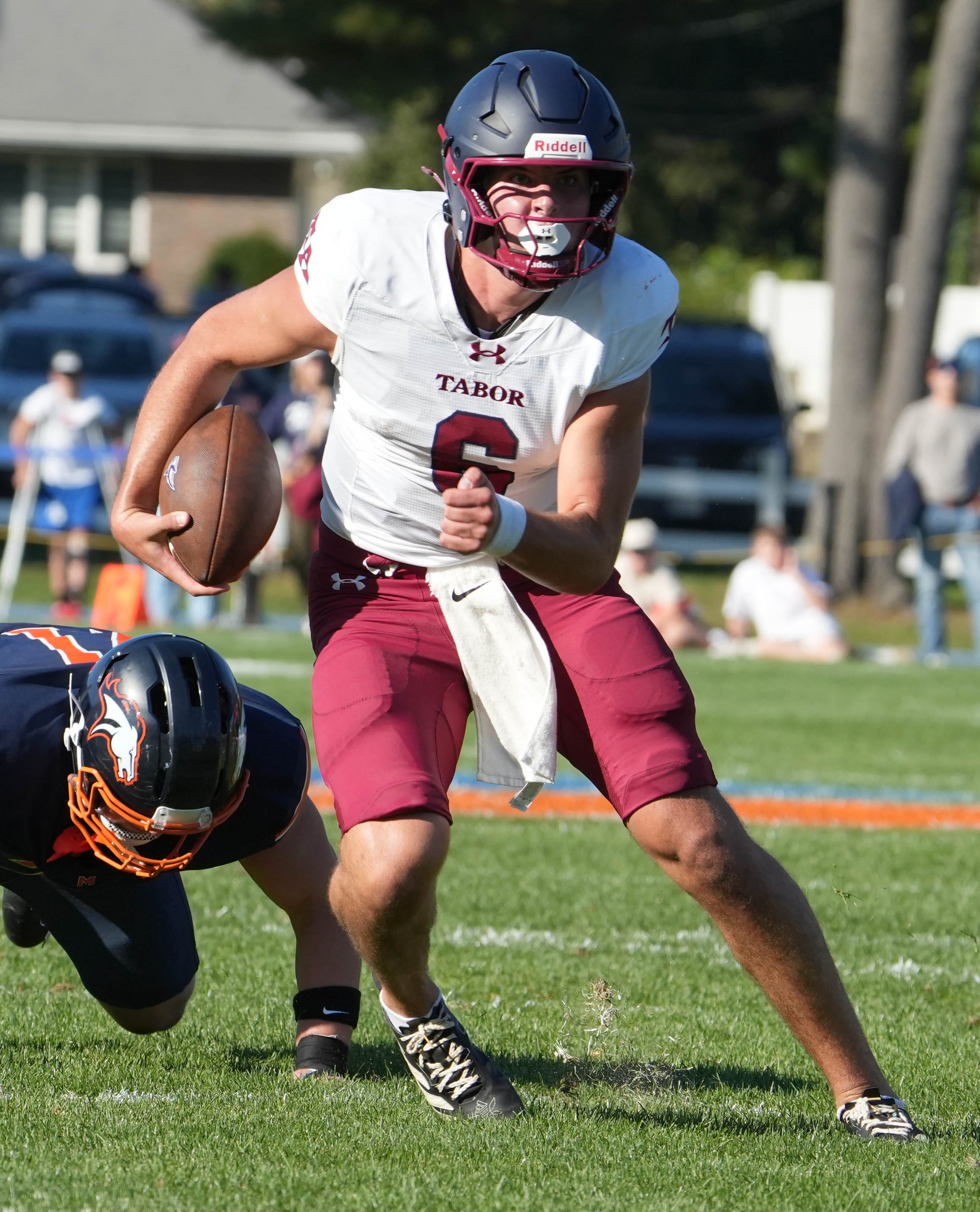 Quarterback Peter Bourque of Tabor Academy carries the football against Milton Academy during their game on Saturday, Oct. 3, 2026.