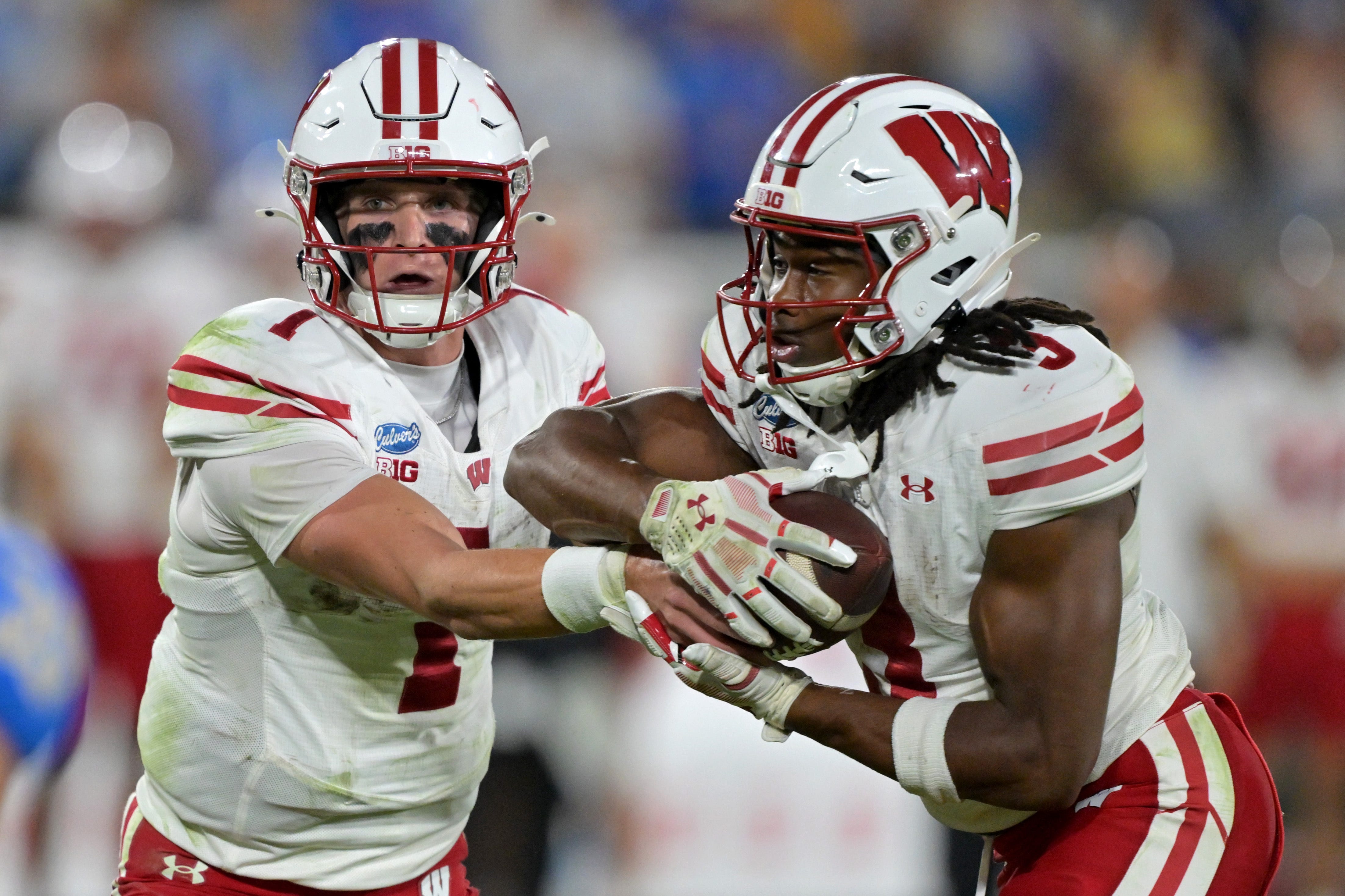 Oct 17, 2026; Pasadena, California, USA;  Wisconsin Badgers quarterback Colton Joseph (1) hands off to running back Abu Sama III (3) in the second half against the UCLA Bruins at the Rose Bowl. Mandatory Credit: Jayne Kamin-Oncea-Imagn Images