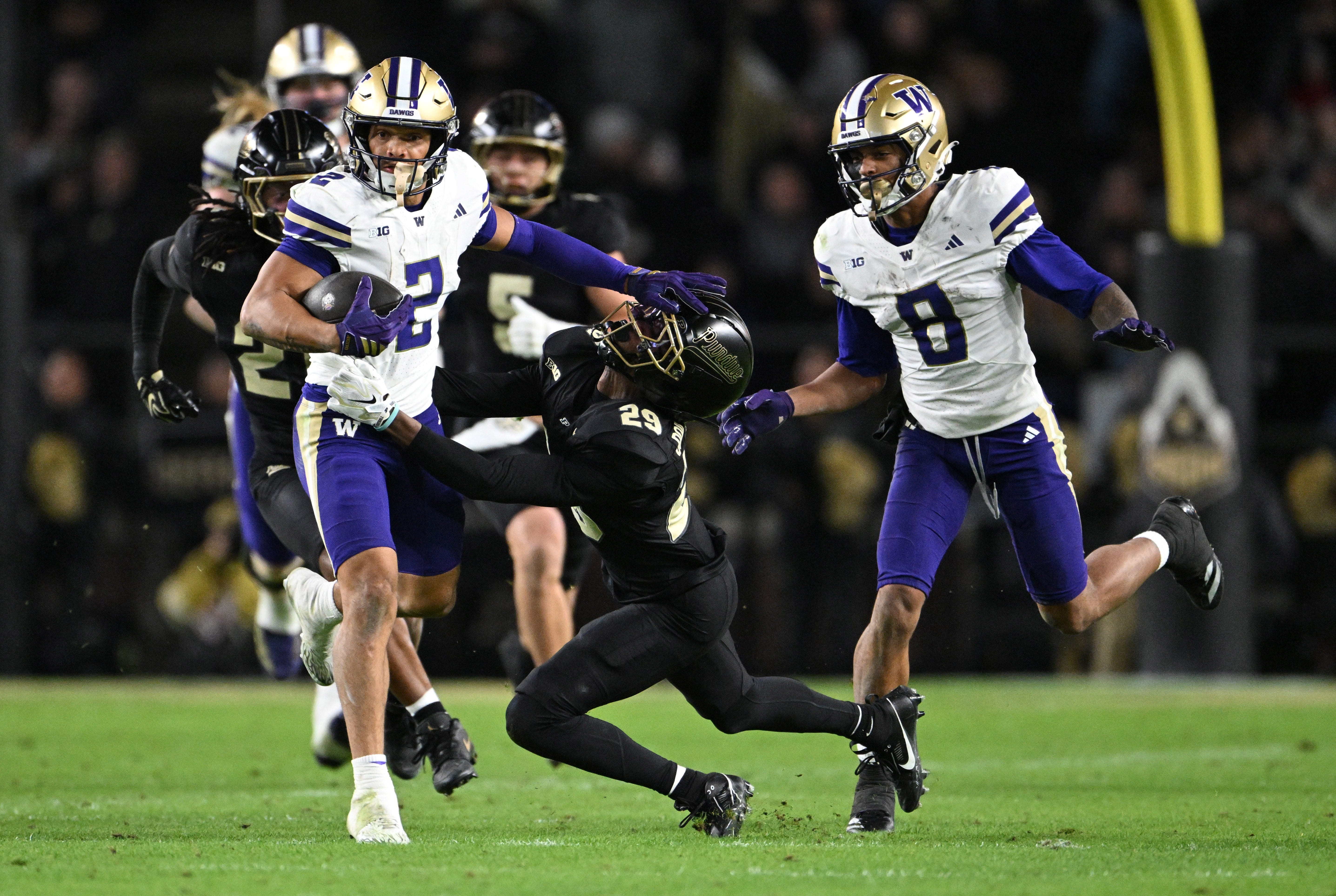 Washington Huskies wide receiver Dezmen Roebuck (2) stiff arms Purdue Boilermakers cornerback Dee Newsome (29) during the second half at Ross-Ade Stadium on Oct. 16, 2026.