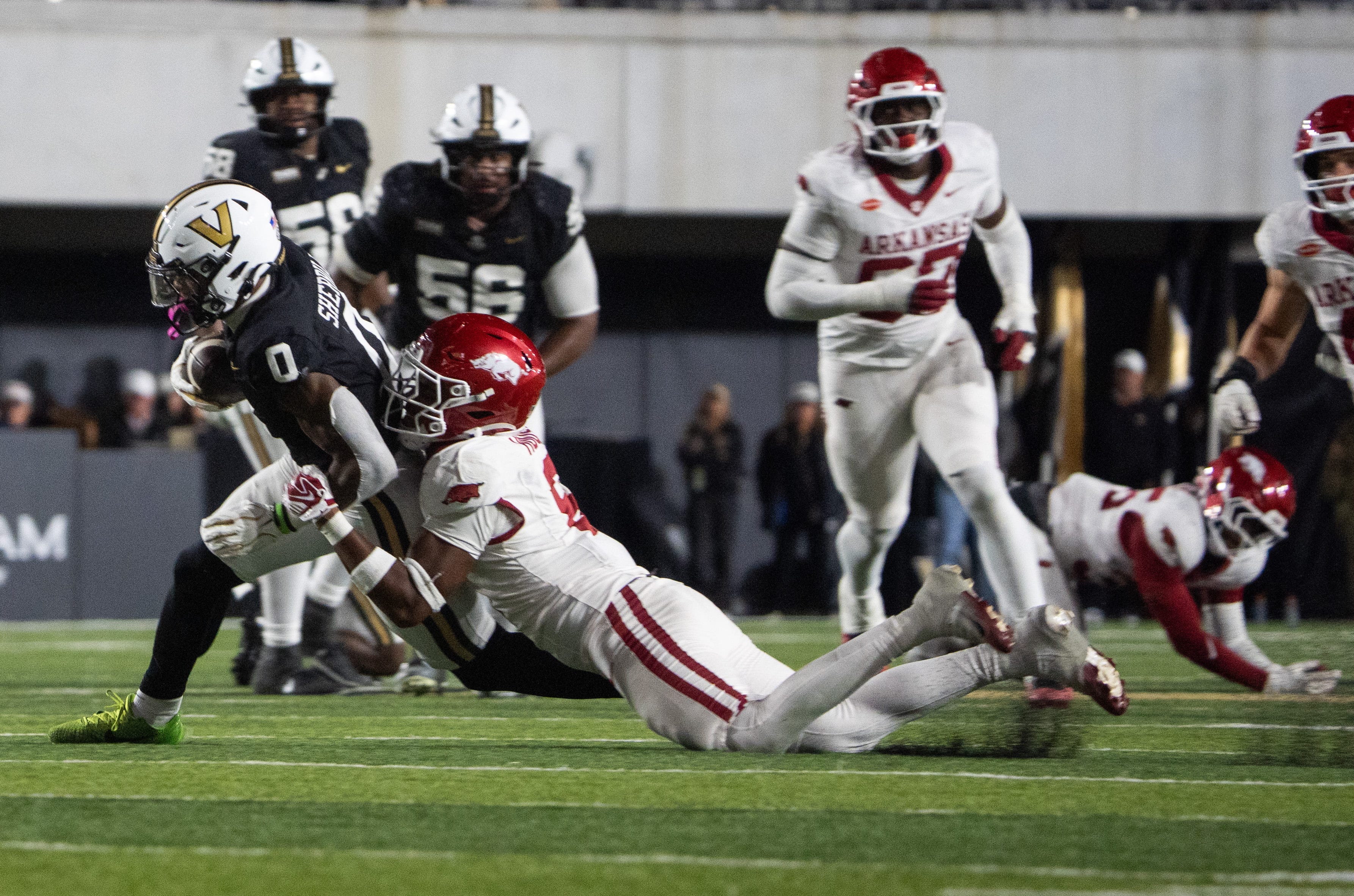 Vanderbilt Commodores wide receiver Junior Sherrill (0) runs the ball being tackled by Arkansas defense during the game between Arkansas Razorbacks and Vanderbilt at FirstBank Stadium in Nashville on Saturday, Oct. 17, 2026.