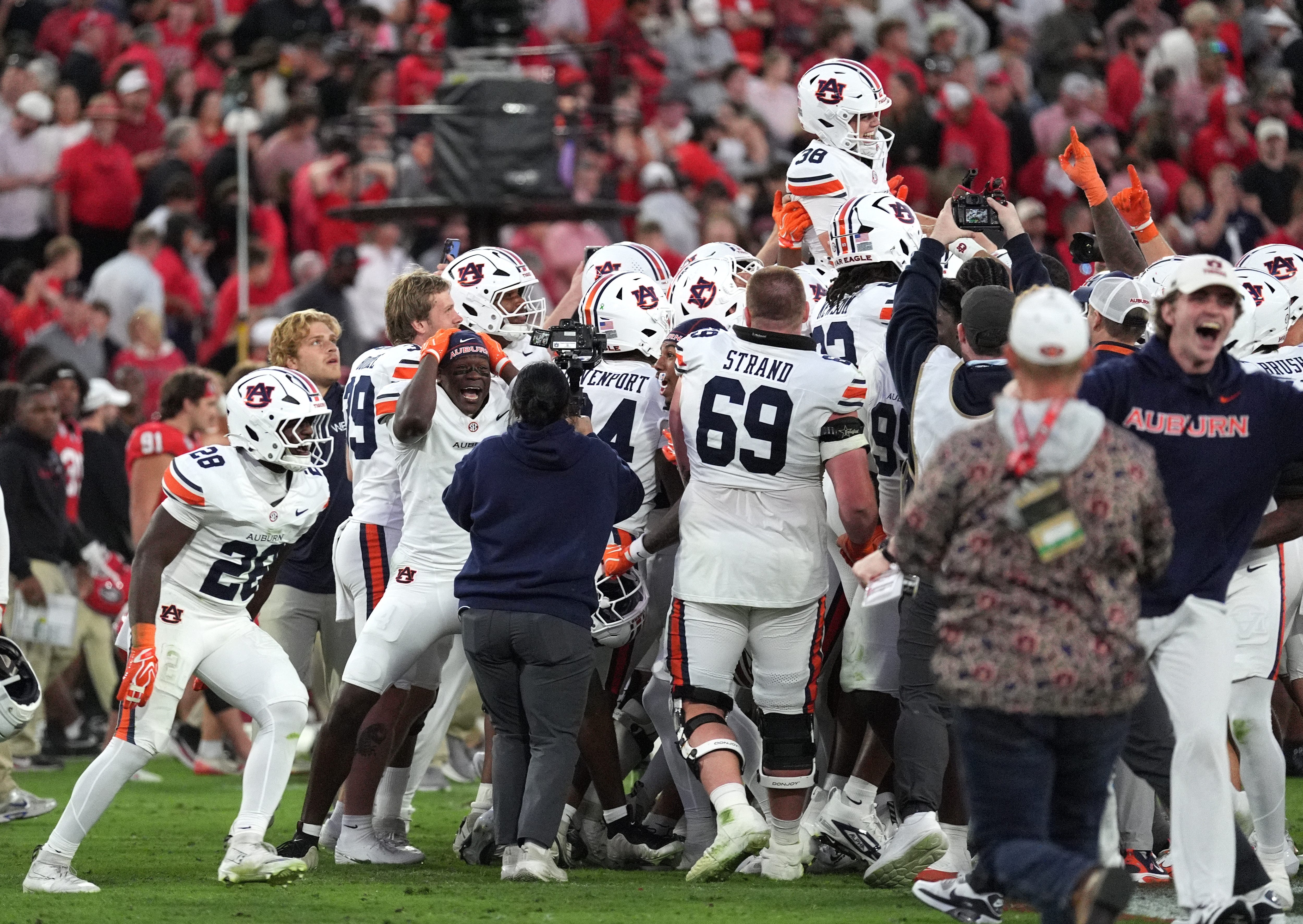 Auburn celebrates following a game-winning field goal by Auburn kicker Alex McPherson during the fourth quarter against Georgia at Sanford Stadium.