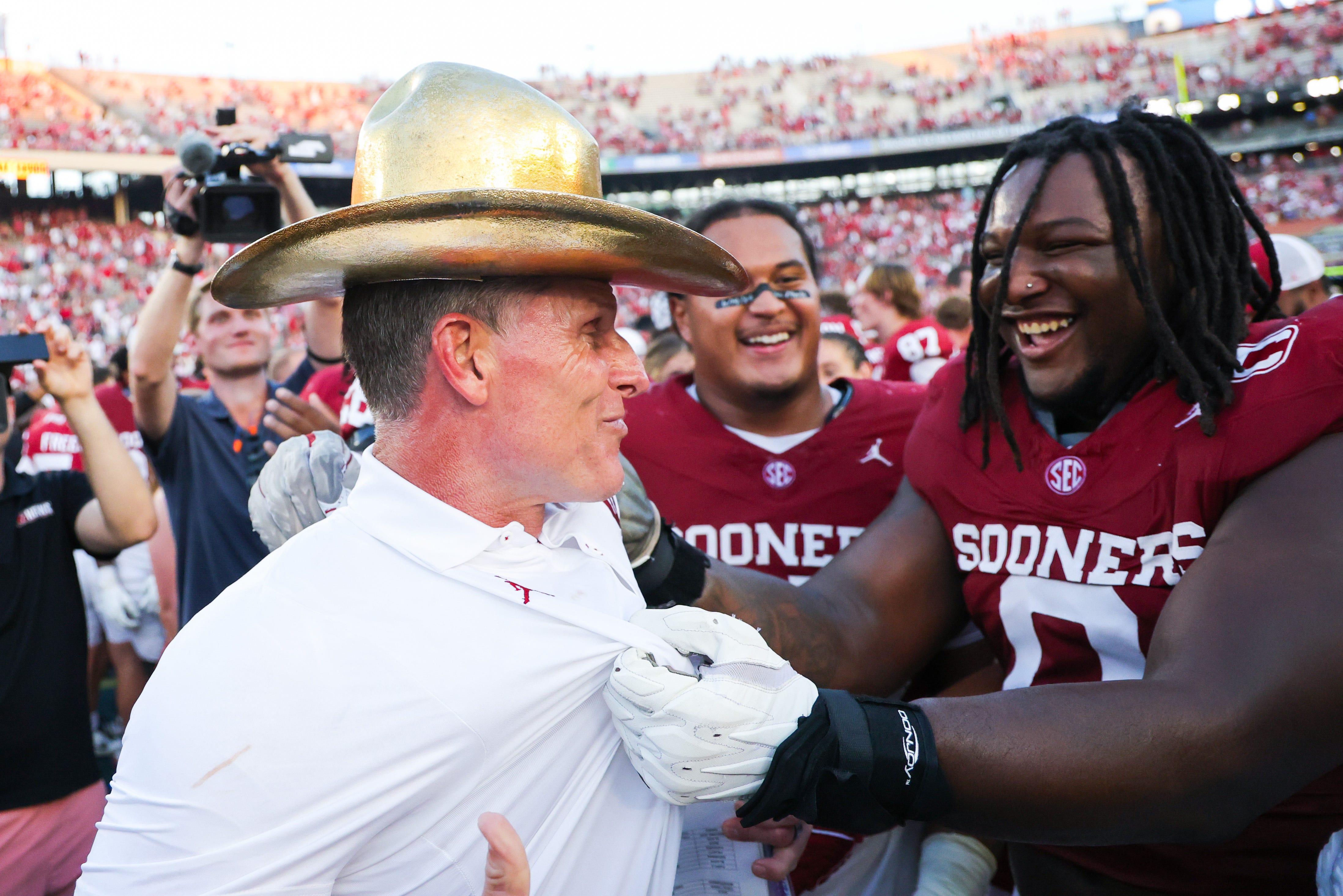 Oct 10, 2026; Dallas, Texas, USA;  Oklahoma Sooners head coach Brent Venables celebrates with Oklahoma Sooners defensive lineman David Stone (0) while wearing the Golden Hat after the game against the Texas Longhorns at Cotton Bowl. Mandatory Credit: Kevin Jairaj-Imagn Images