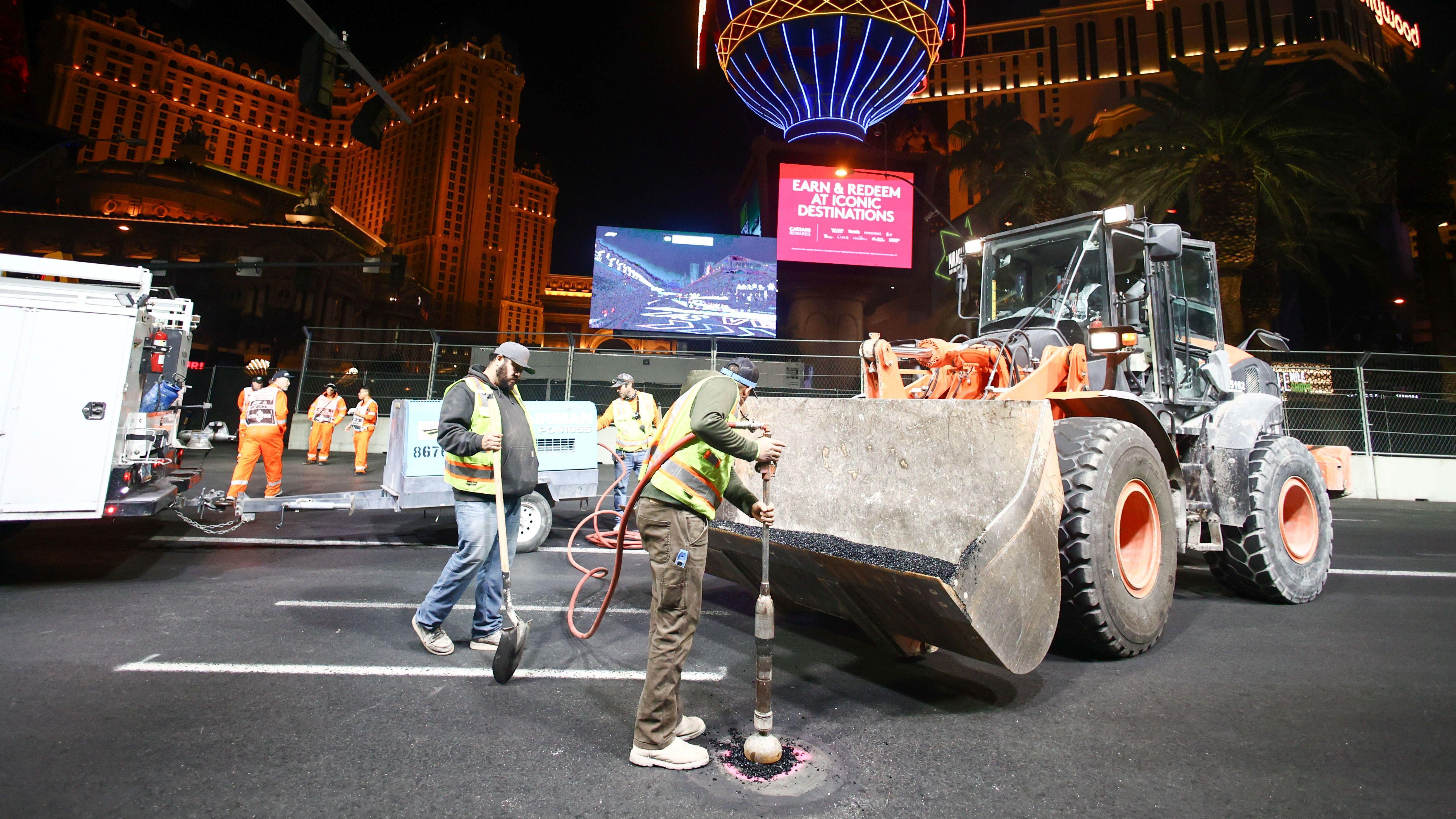 Repairs to a manhole cover take place during the 2023 Las Vegas Grand Prix