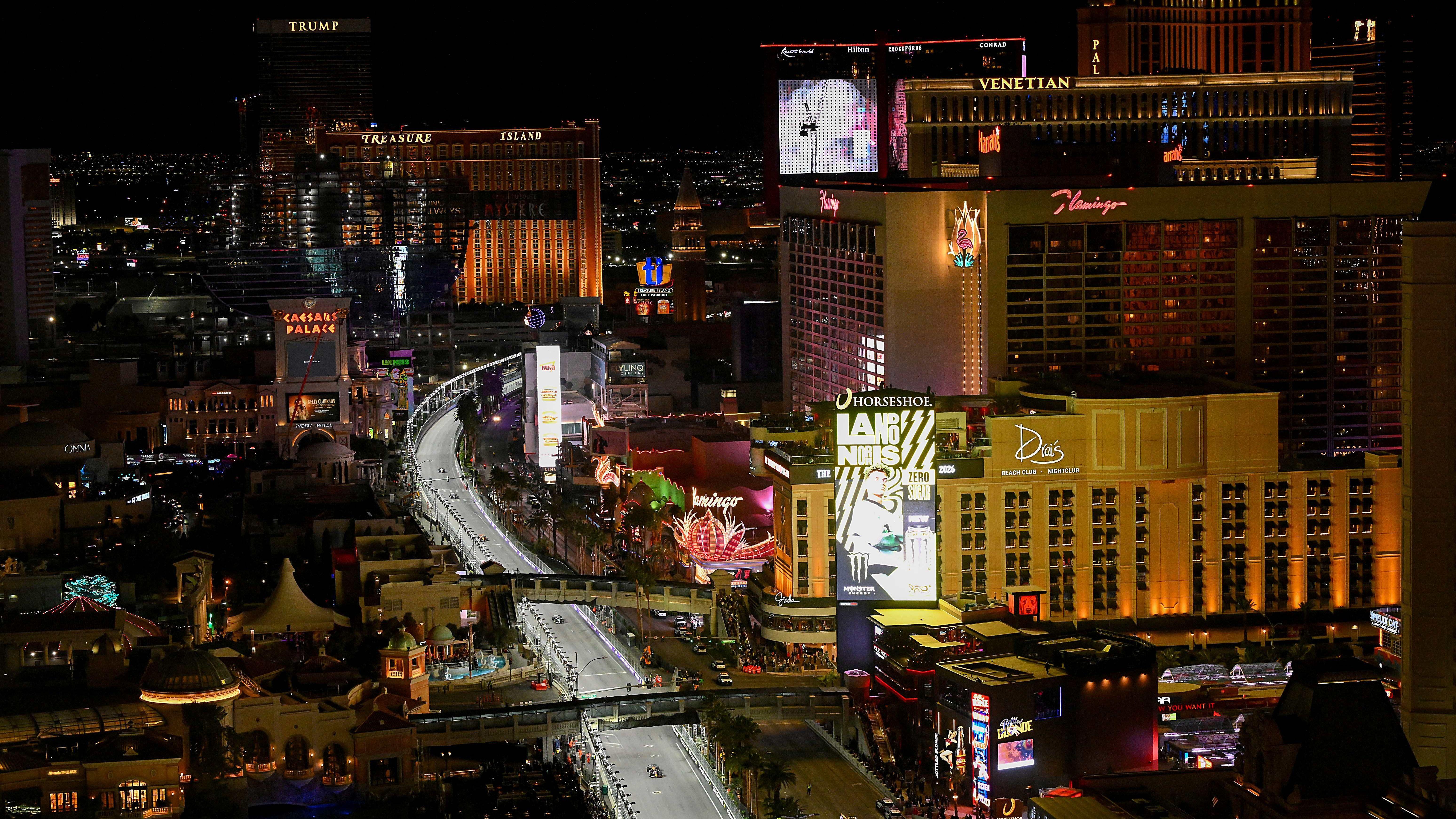 Red Bull's Max Verstappen leads the field down the Strip during the 2025 Las Vegas Grand Prix. Illuminated builds visible include the Trump International Hotel, Caesars Palace and The Venetian