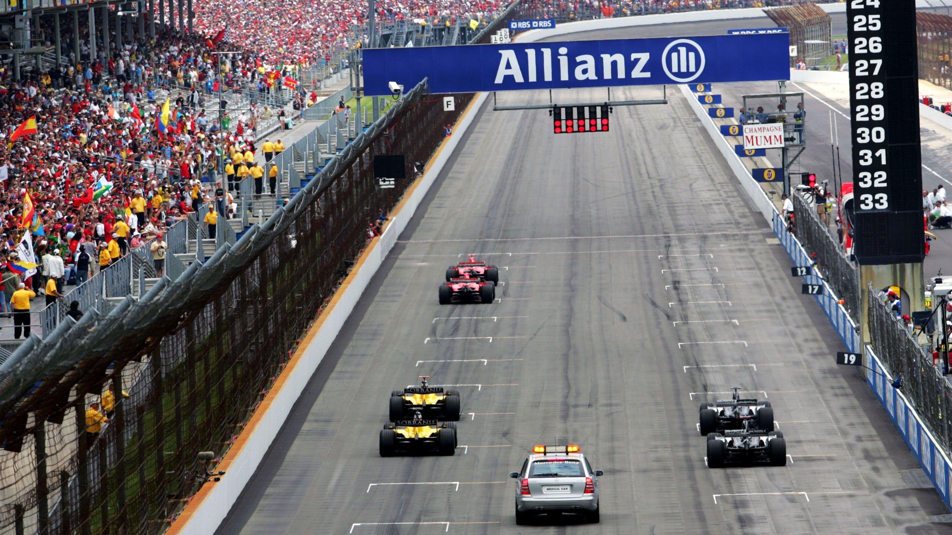 A rear view of six cars lined up at the start of the 2005 US Grand Prix at Indianapolis Motor Speedway