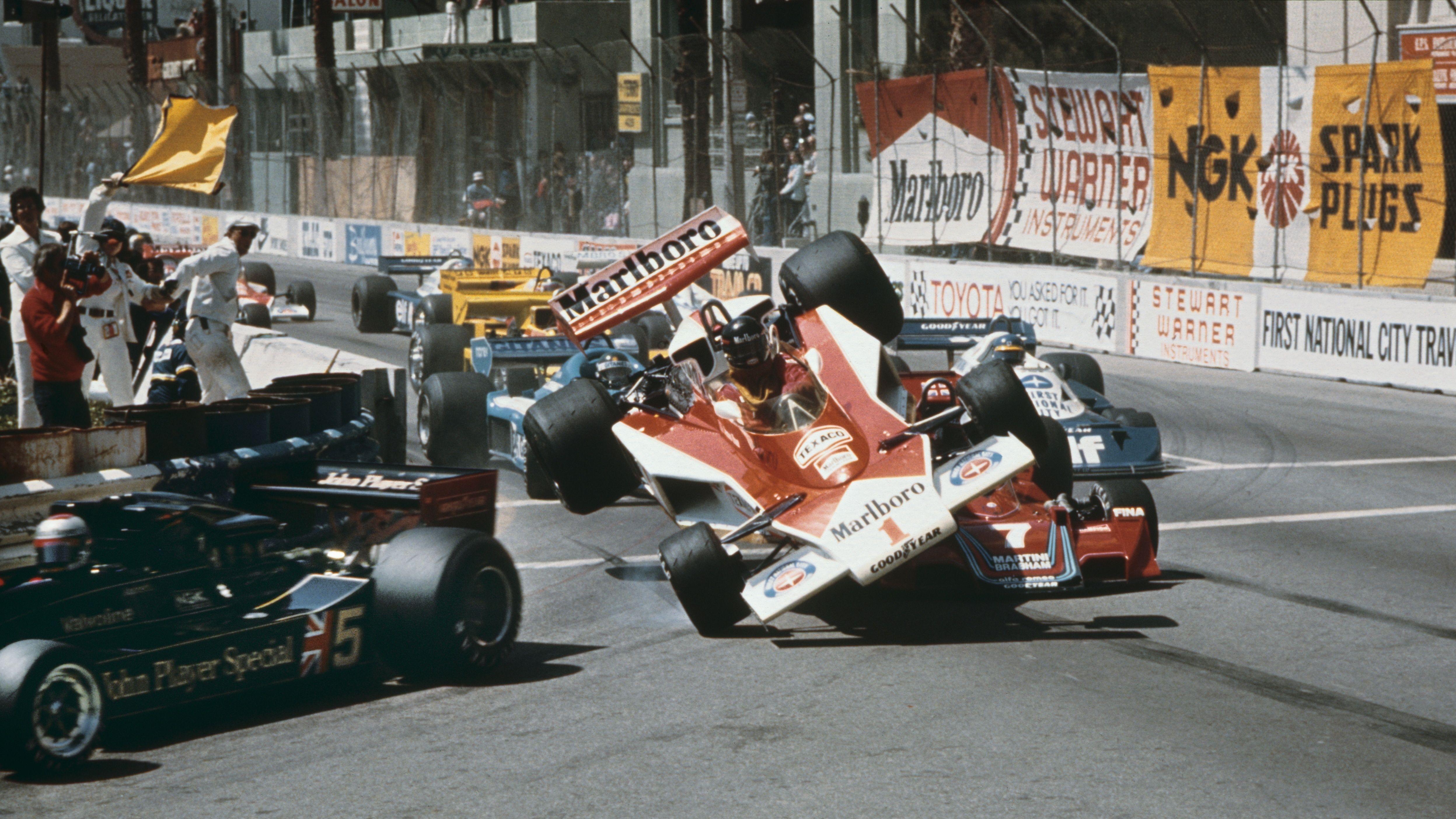The McLaren of James Hunt is tipped into the air as it collides with Brabham of John Watson at the start of the 1977 Long Beach Grand Prix