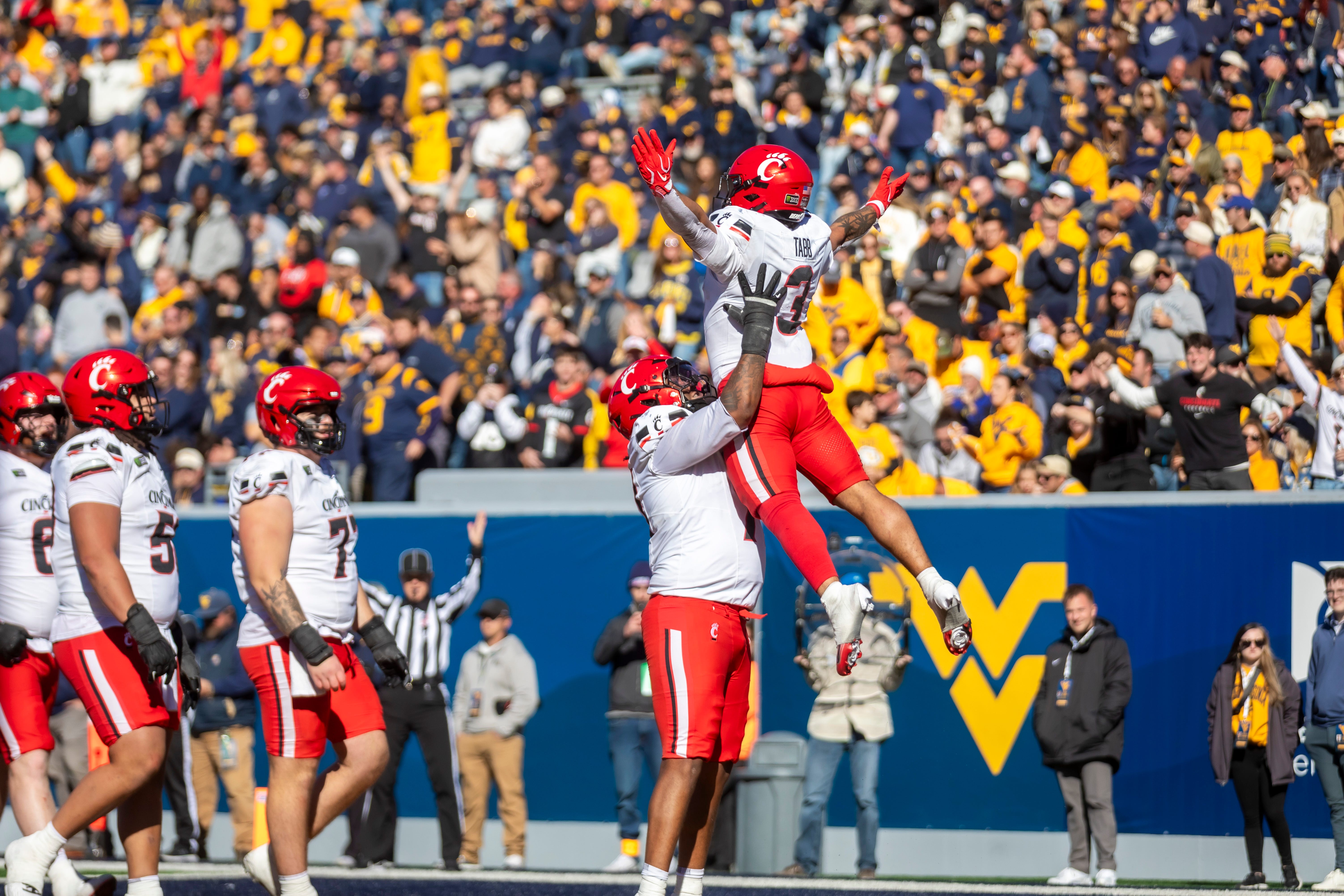 Oct 17, 2026; Morgantown, West Virginia, USA;  Cincinnati Bearcats running back Cole Tabb (3) celebrates with teammates after scoring a touchdown during the fourth quarter against the West Virginia Mountaineers at Milan Puskar Stadium.  Mandatory Credit: Ben Queen-Imagn Images
