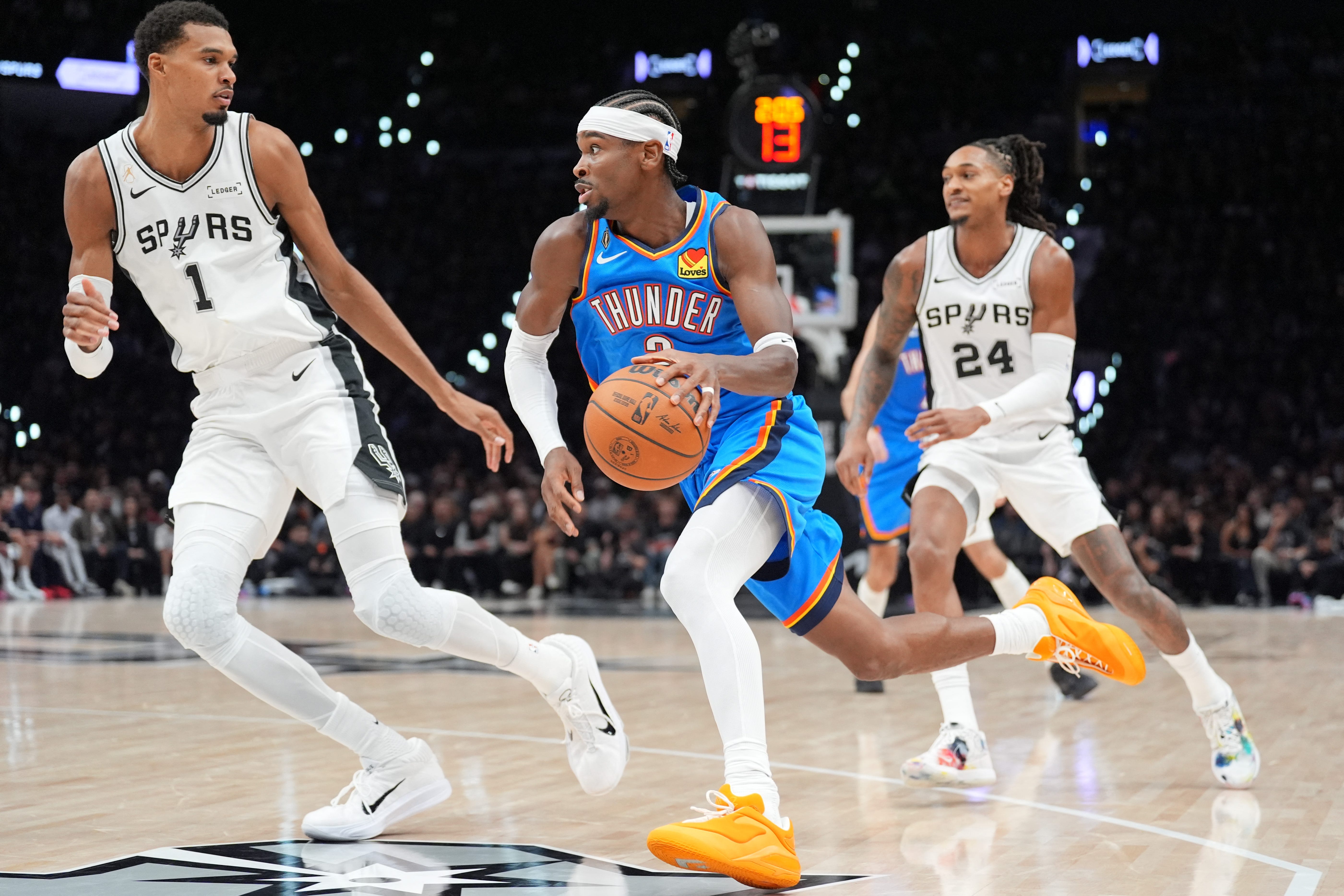 Oct 20, 2026; San Antonio, Texas, USA;  Oklahoma City Thunder guard Shai Gilgeous-Alexander (2) dribbles against San Antonio Spurs forward Victor Wembanyama (1) in the first half at Frost Bank Center.  Mandatory Credit: Daniel Dunn-Imagn Images