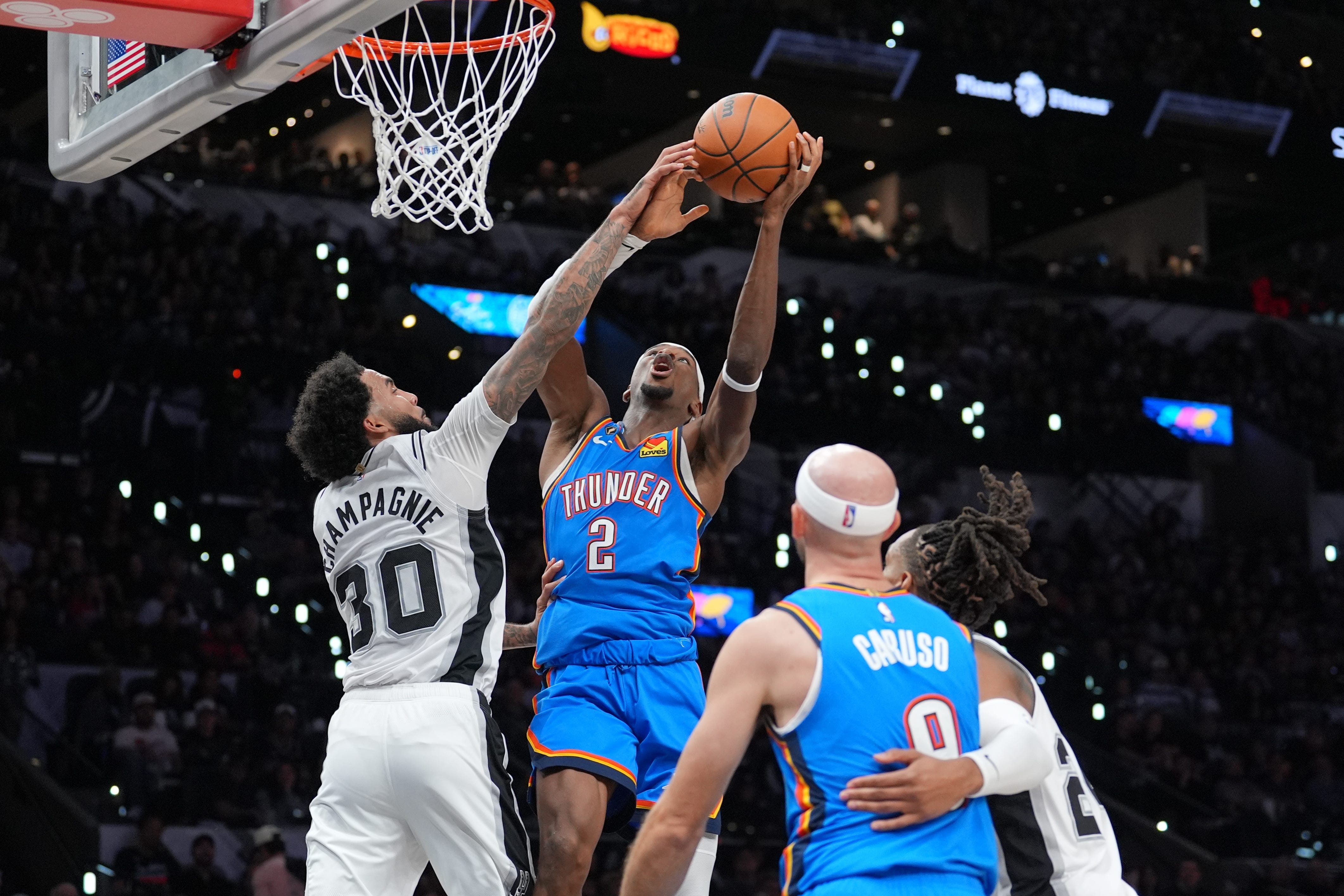 Oct 20, 2026; San Antonio, Texas, USA;  Oklahoma City Thunder guard Shai Gilgeous-Alexander (2) shoots against San Antonio Spurs forward Julian Champagnie (30) in the first half at Frost Bank Center.  Mandatory Credit: Daniel Dunn-Imagn Images