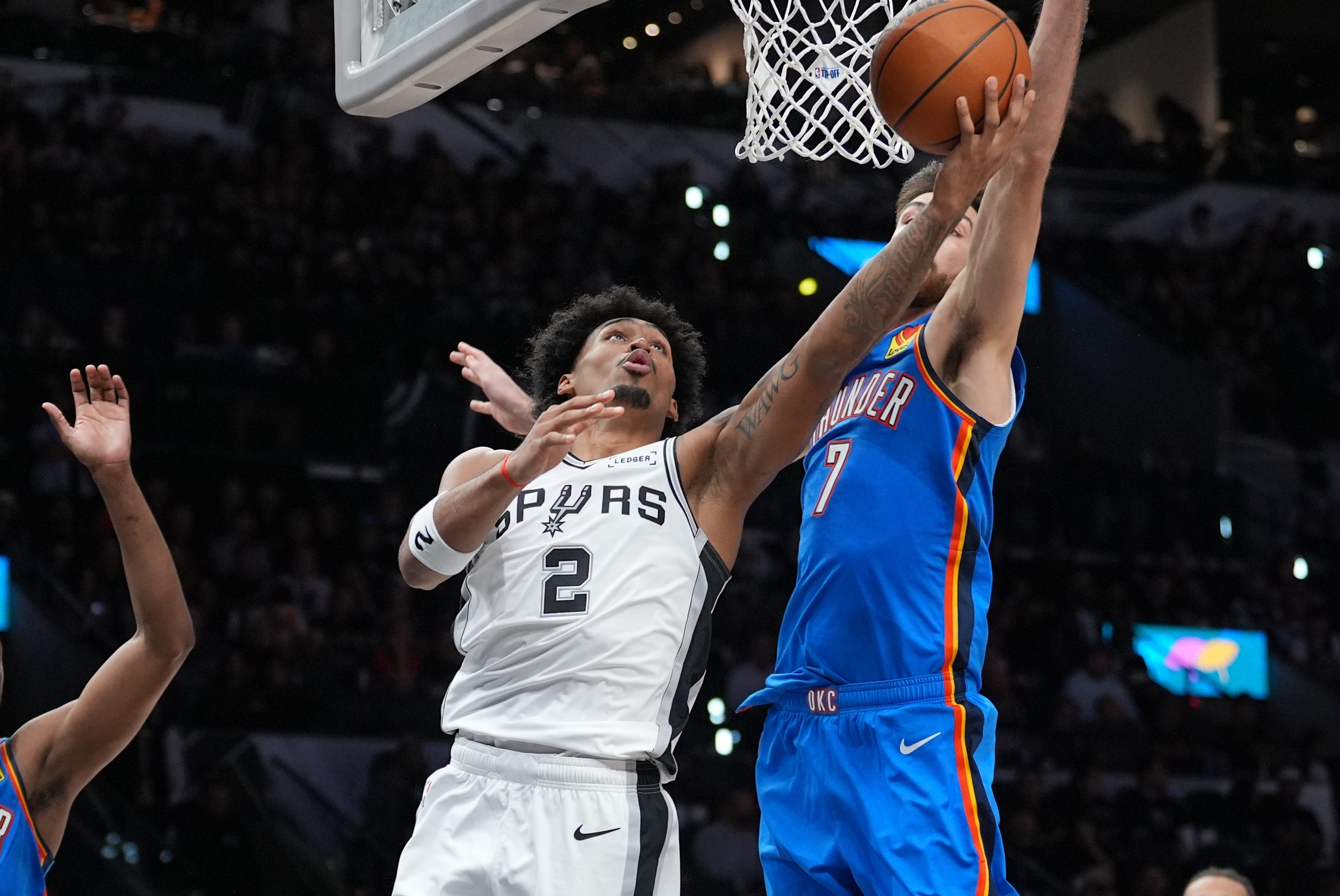 Oct 20, 2026; San Antonio, Texas, USA;  San Antonio Spurs guard Dylan Harper (2) shoots under the arm of Oklahoma City Thunder center Chet Holmgren (7) in the second half at Frost Bank Center.  Mandatory Credit: Daniel Dunn-Imagn Images
