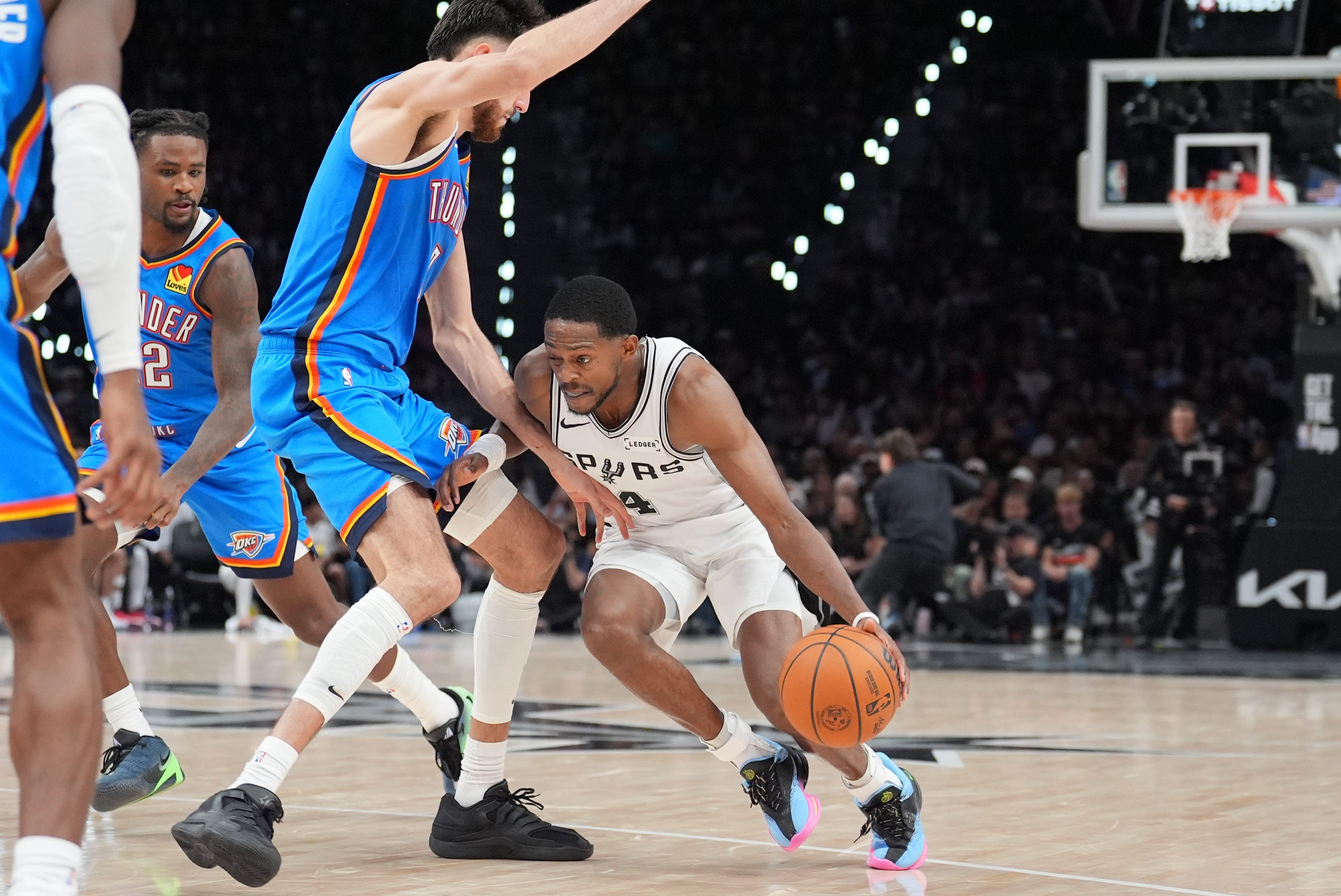 Oct 20, 2026; San Antonio, Texas, USA;  San Antonio Spurs guard De'aaron Fox (4) dribbles against Oklahoma City Thunder center Chet Holmgren (7) in the second half at Frost Bank Center.  Mandatory Credit: Daniel Dunn-Imagn Images