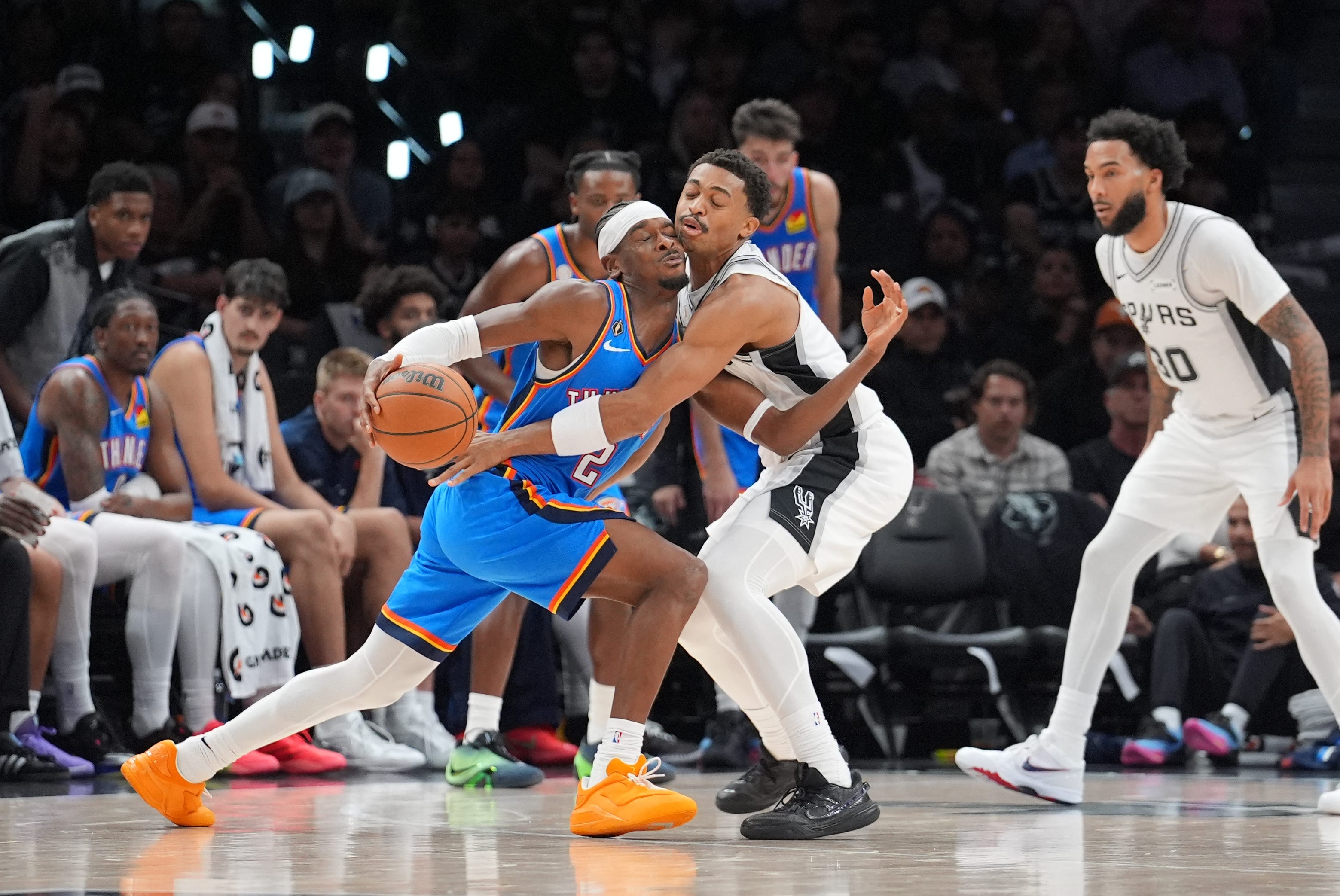 Oct 20, 2026; San Antonio, Texas, USA;  Oklahoma City Thunder guard Shai Gilgeous-Alexander (2) collides with San Antonio Spurs forward Keldon Johnson (3) in the second half at Frost Bank Center.  Mandatory Credit: Daniel Dunn-Imagn Images