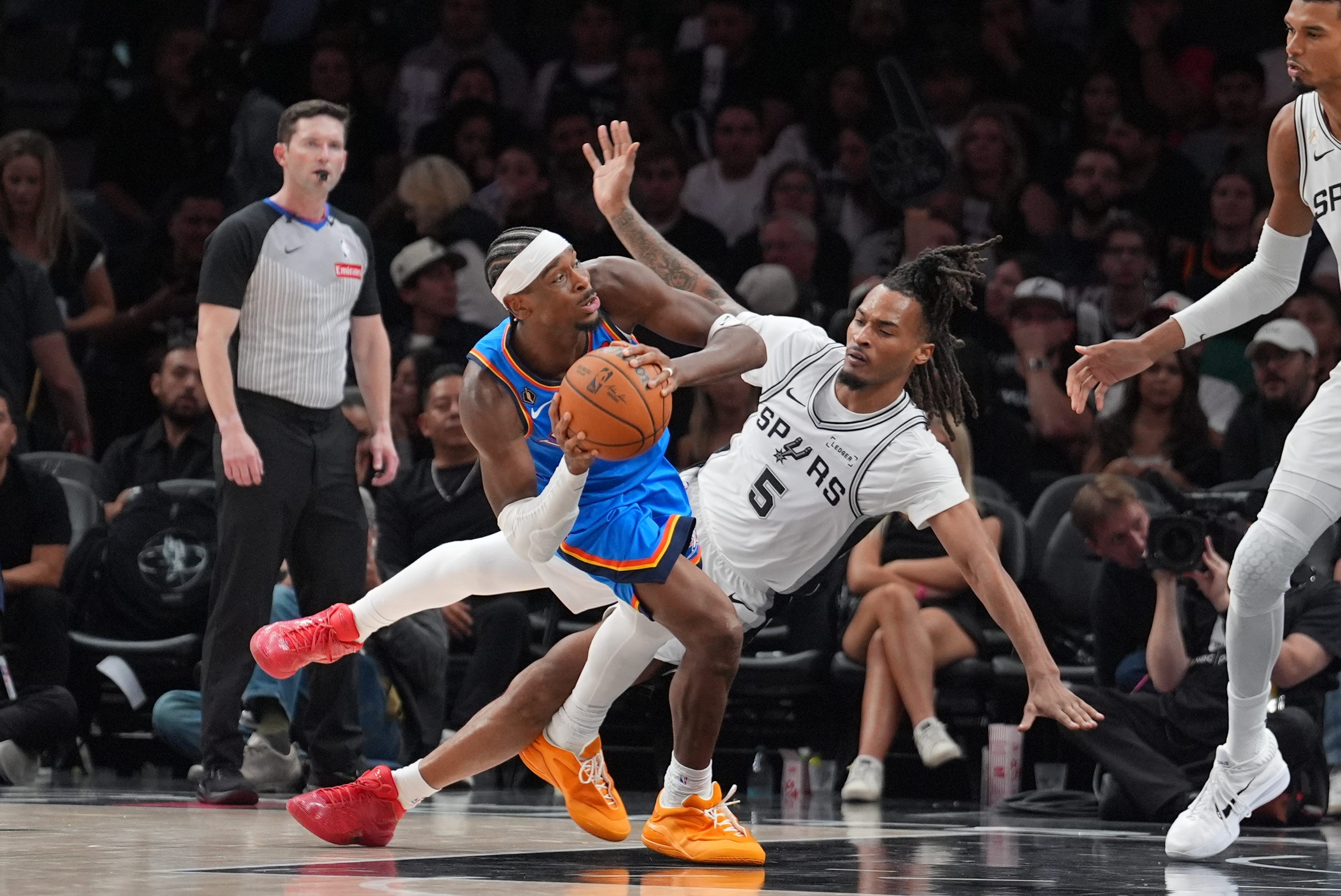 Oct 20, 2026; San Antonio, Texas, USA;  Oklahoma City Thunder guard Shai Gilgeous-Alexander (2) collides with San Antonio Spurs guard Stephon Castle (5) in the second half at Frost Bank Center.  Mandatory Credit: Daniel Dunn-Imagn Images
