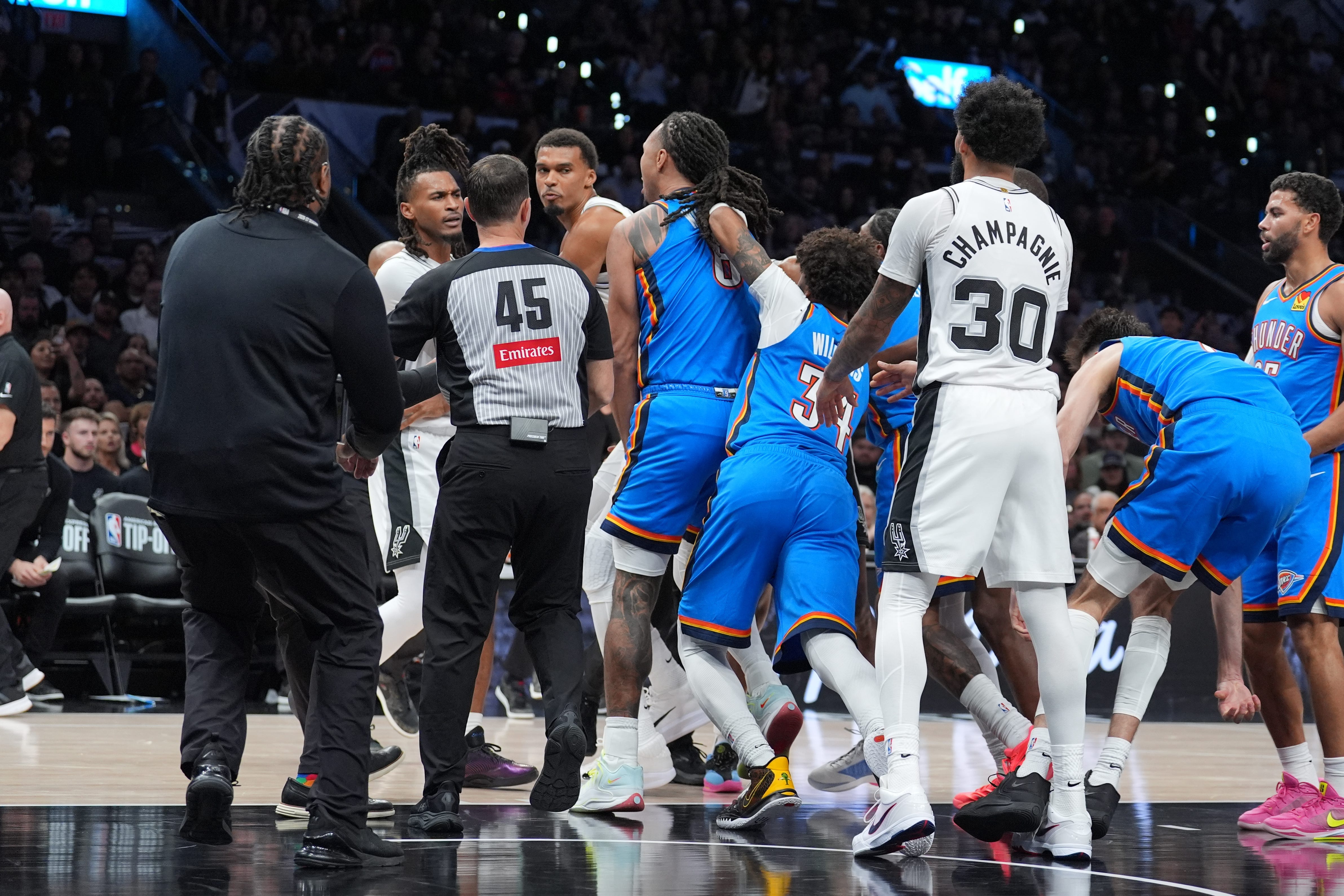 Oct 20, 2026; San Antonio, Texas, USA;  Oklahoma City Thunder forward Jaylin Williams (6) gets in an altercation with San Antonio Spurs forward Victor Wembanyama (1) in the first half at Frost Bank Center.  Mandatory Credit: Daniel Dunn-Imagn Images