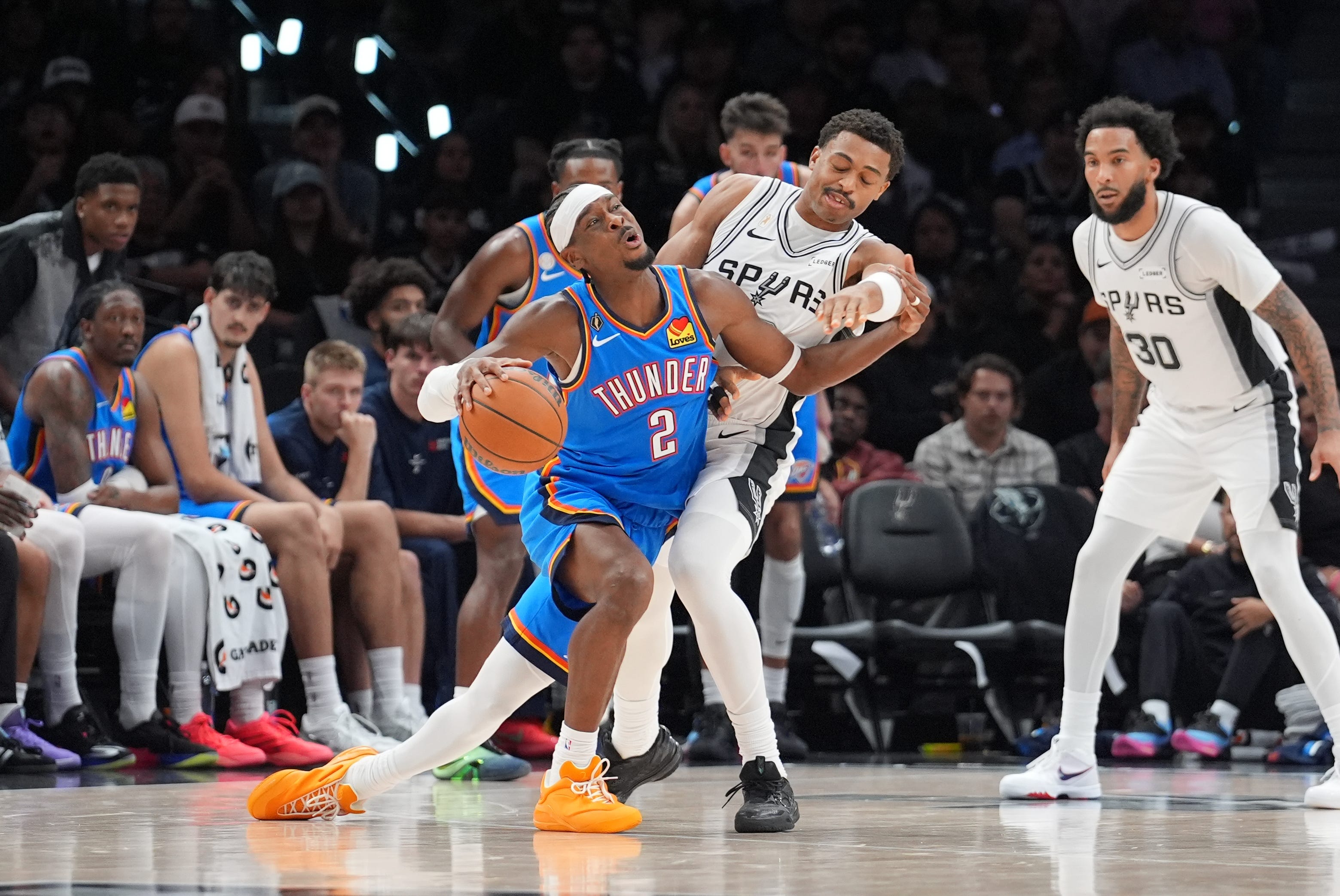 Oct 20, 2026; San Antonio, Texas, USA;  Oklahoma City Thunder guard Shai Gilgeous-Alexander (2) collides with San Antonio Spurs forward Keldon Johnson (3) in the second half at Frost Bank Center.  Mandatory Credit: Daniel Dunn-Imagn Images