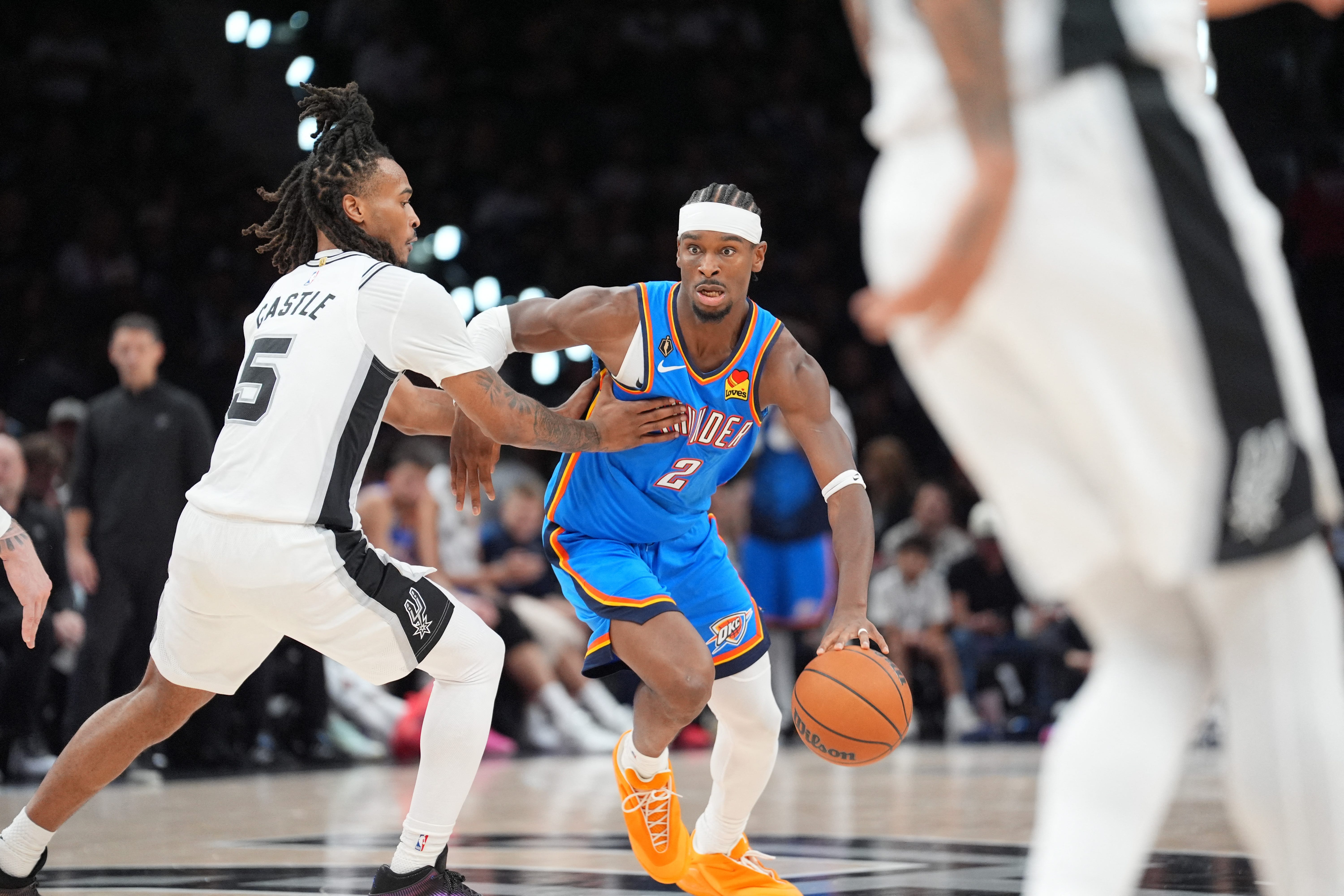 Oct 20, 2026; San Antonio, Texas, USA;  Oklahoma City Thunder guard Shai Gilgeous-Alexander (2) dribbles against San Antonio Spurs guard Stephon Castle (5) in the first half at Frost Bank Center.  Mandatory Credit: Daniel Dunn-Imagn Images