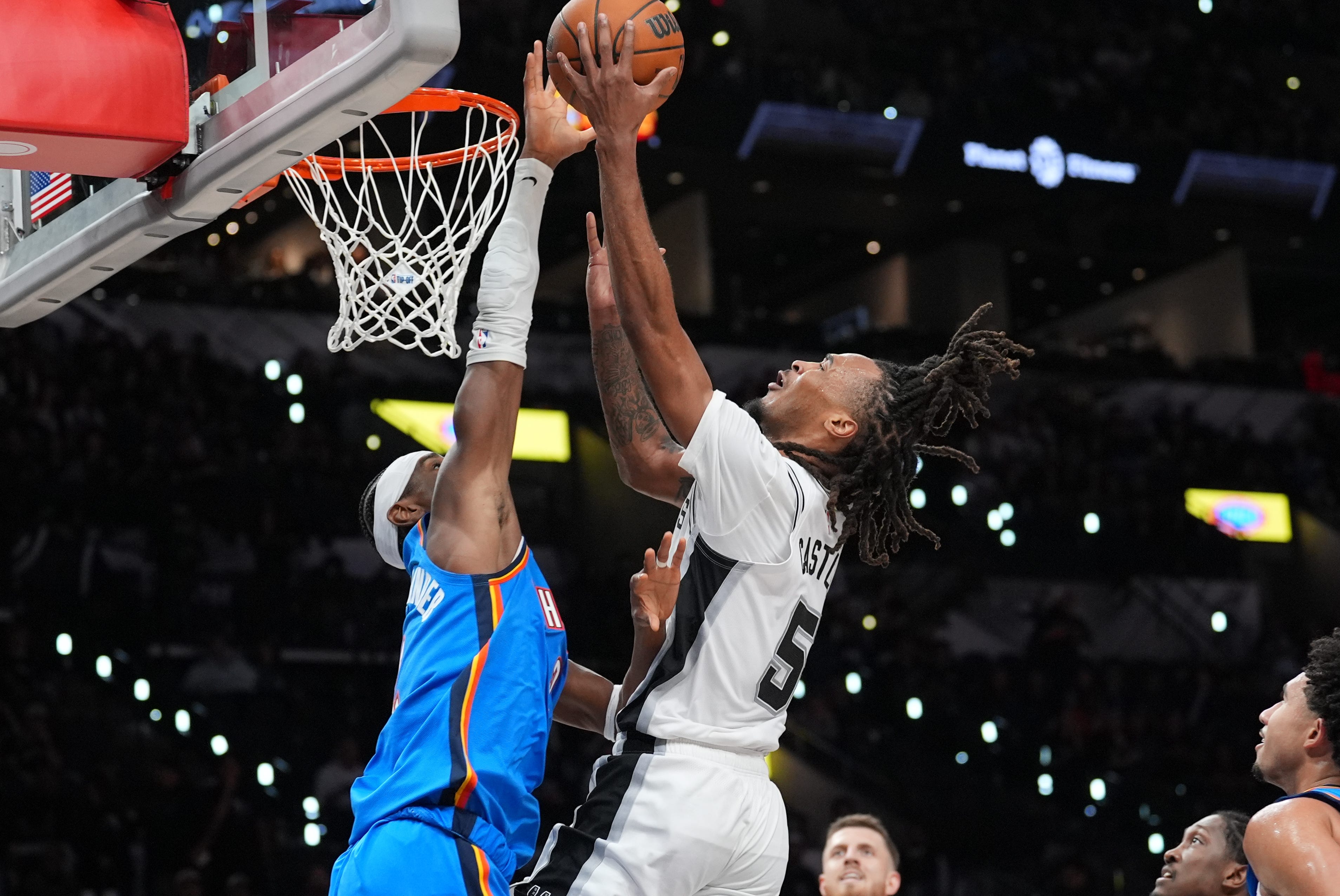 Oct 20, 2026; San Antonio, Texas, USA;  San Antonio Spurs guard Stephon Castle (5) shoots against Oklahoma City Thunder guard Shai Gilgeous-Alexander (2) in the second half at Frost Bank Center.  Mandatory Credit: Daniel Dunn-Imagn Images