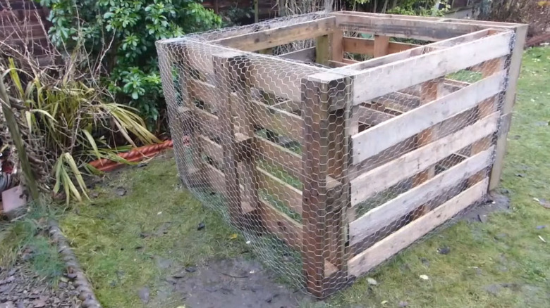Man Uses Old Wood Pallets To Create A Backyard Compost Bin With A ...