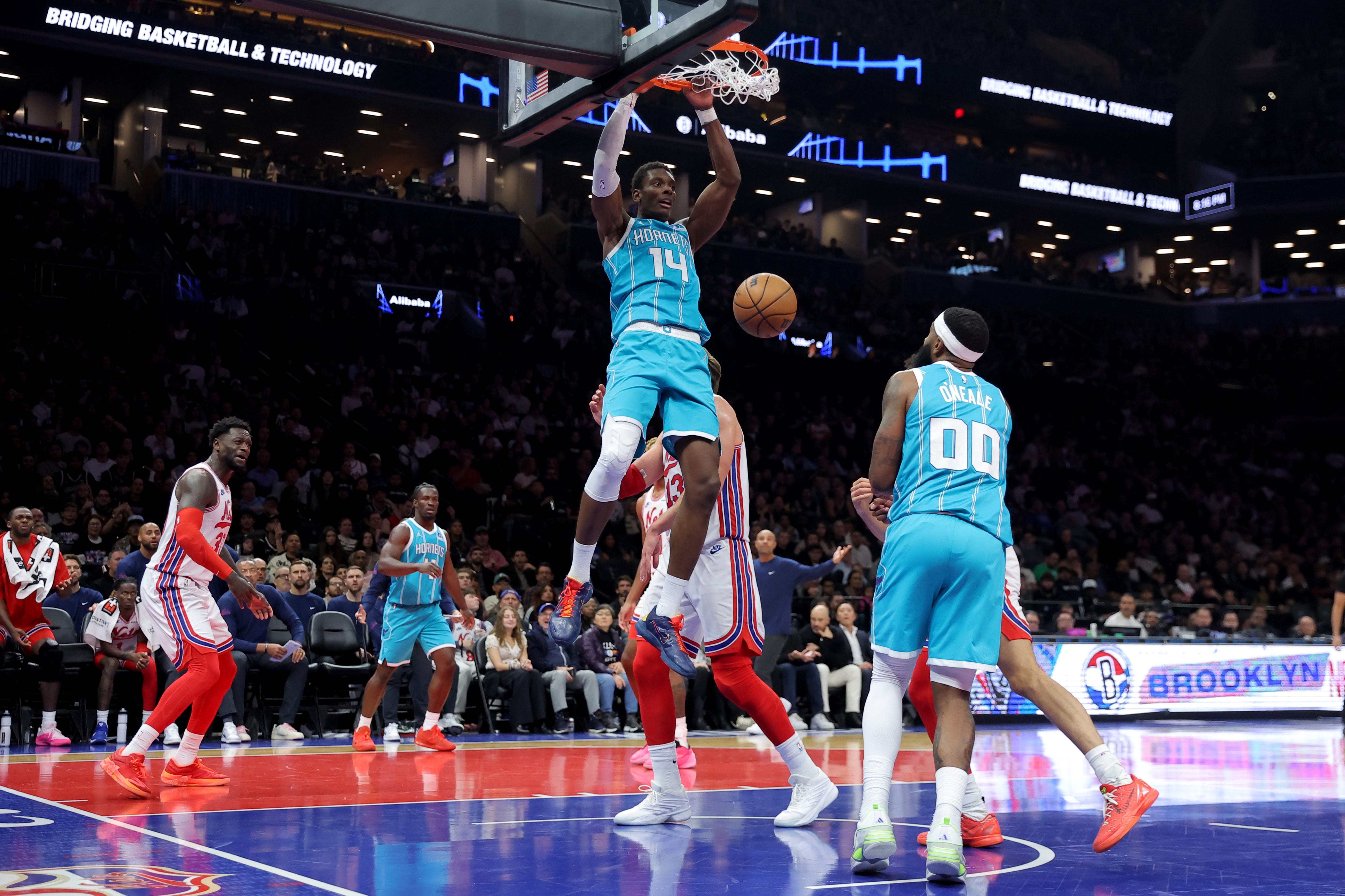 Oct 21, 2026; Brooklyn, New York, USA; Charlotte Hornets forward Moussa Diabate (14) dunks against Brooklyn Nets center Moritz Wagner (13) during the first quarter at Barclays Center. Mandatory Credit: Brad Penner-Imagn Images