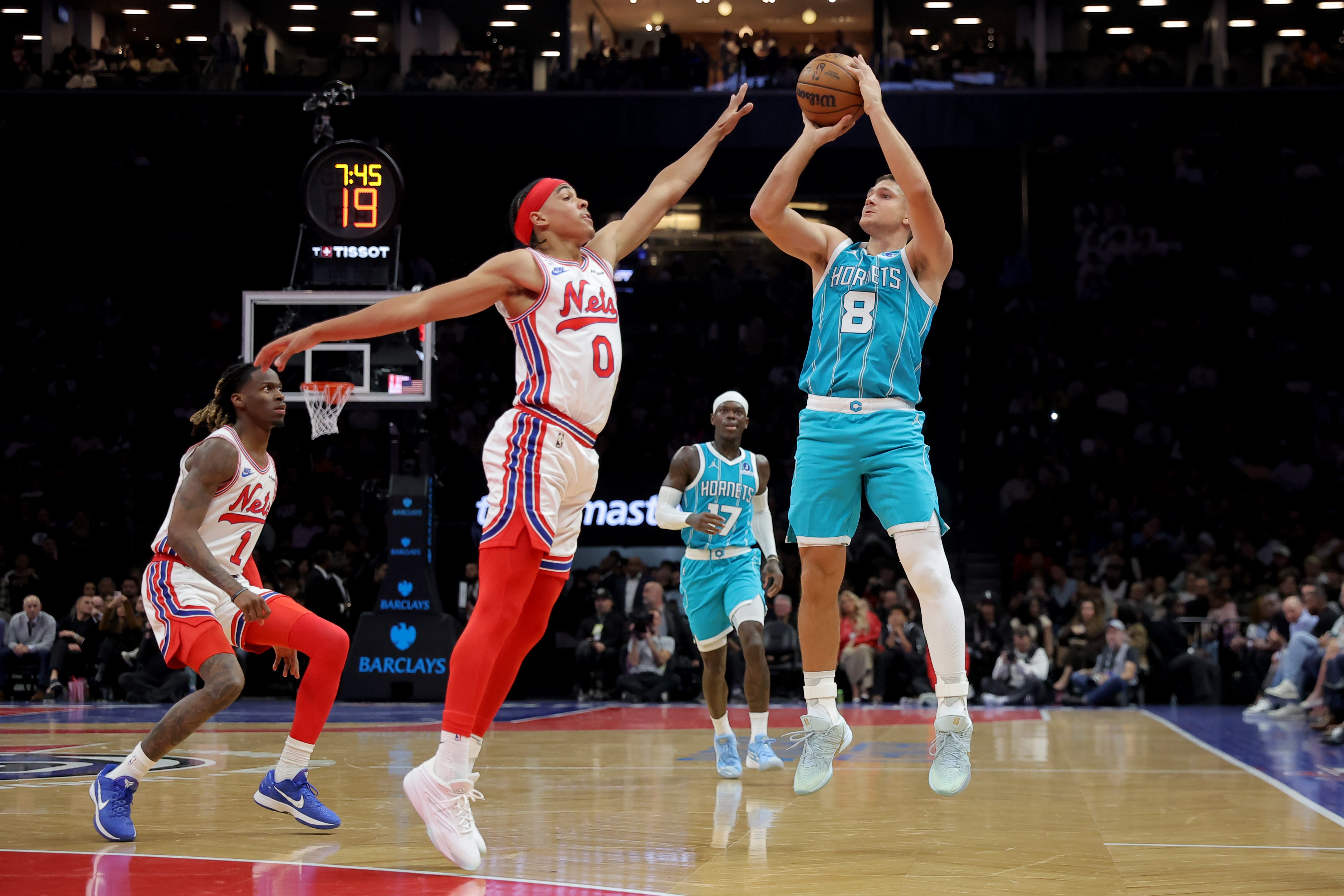 Oct 21, 2026; Brooklyn, New York, USA; Charlotte Hornets guard Grayson Allen (8) shoots a three point shot against Brooklyn Nets guards Mikel Brown Jr. (0) and Keon Ellis (1) during the second quarter at Barclays Center. Mandatory Credit: Brad Penner-Imagn Images