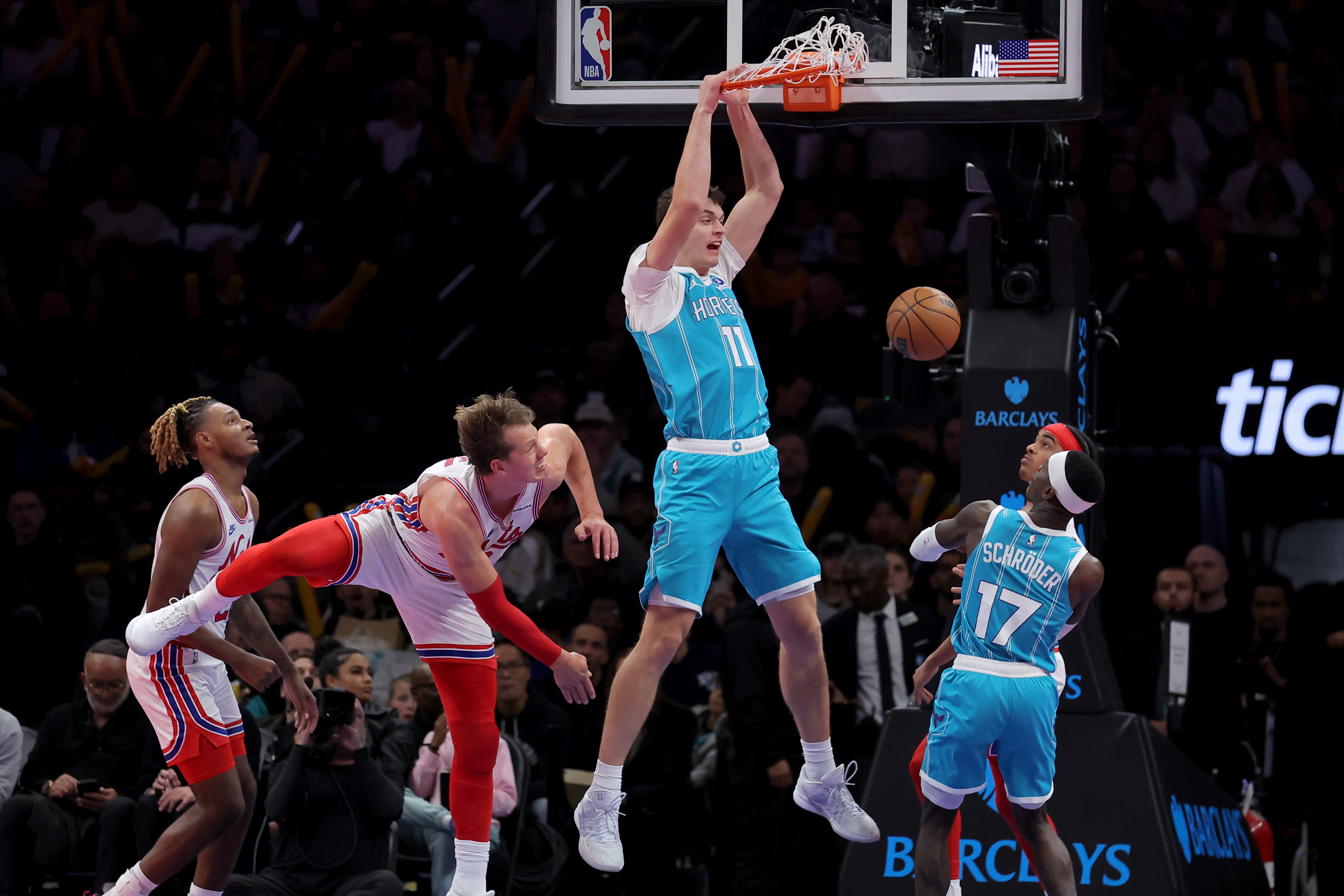 Oct 21, 2026; Brooklyn, New York, USA; Charlotte Hornets center Ryan Kalkbrenner (11) dunks against Brooklyn Nets center Moritz Wagner (13) during the third quarter at Barclays Center. Mandatory Credit: Brad Penner-Imagn Images