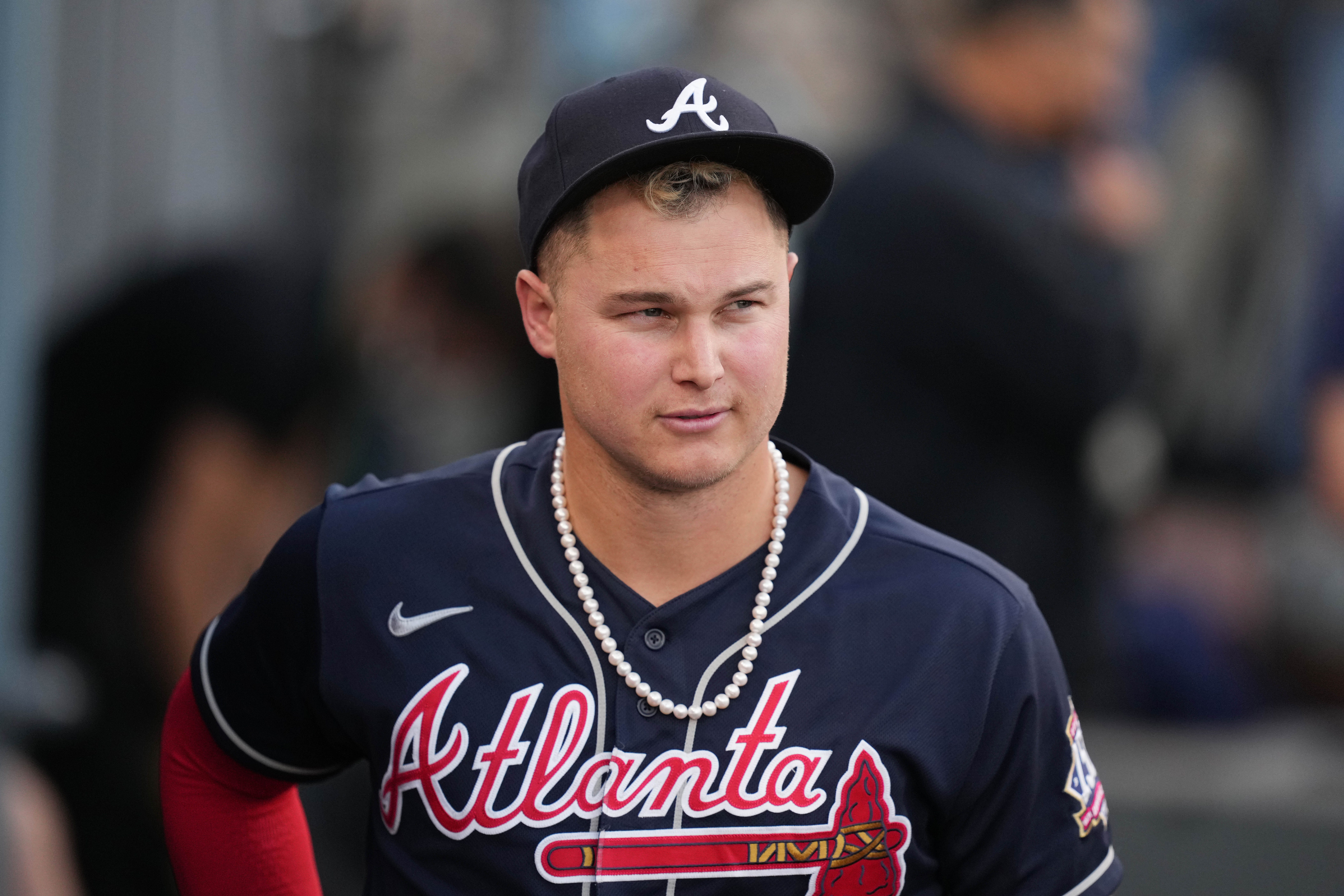Atlanta Braves right fielder Joc Pederson (22) wears pearls in the dugout before game five of the 2021 NLCS against the Los Angeles Dodgers at Dodger Stadium.