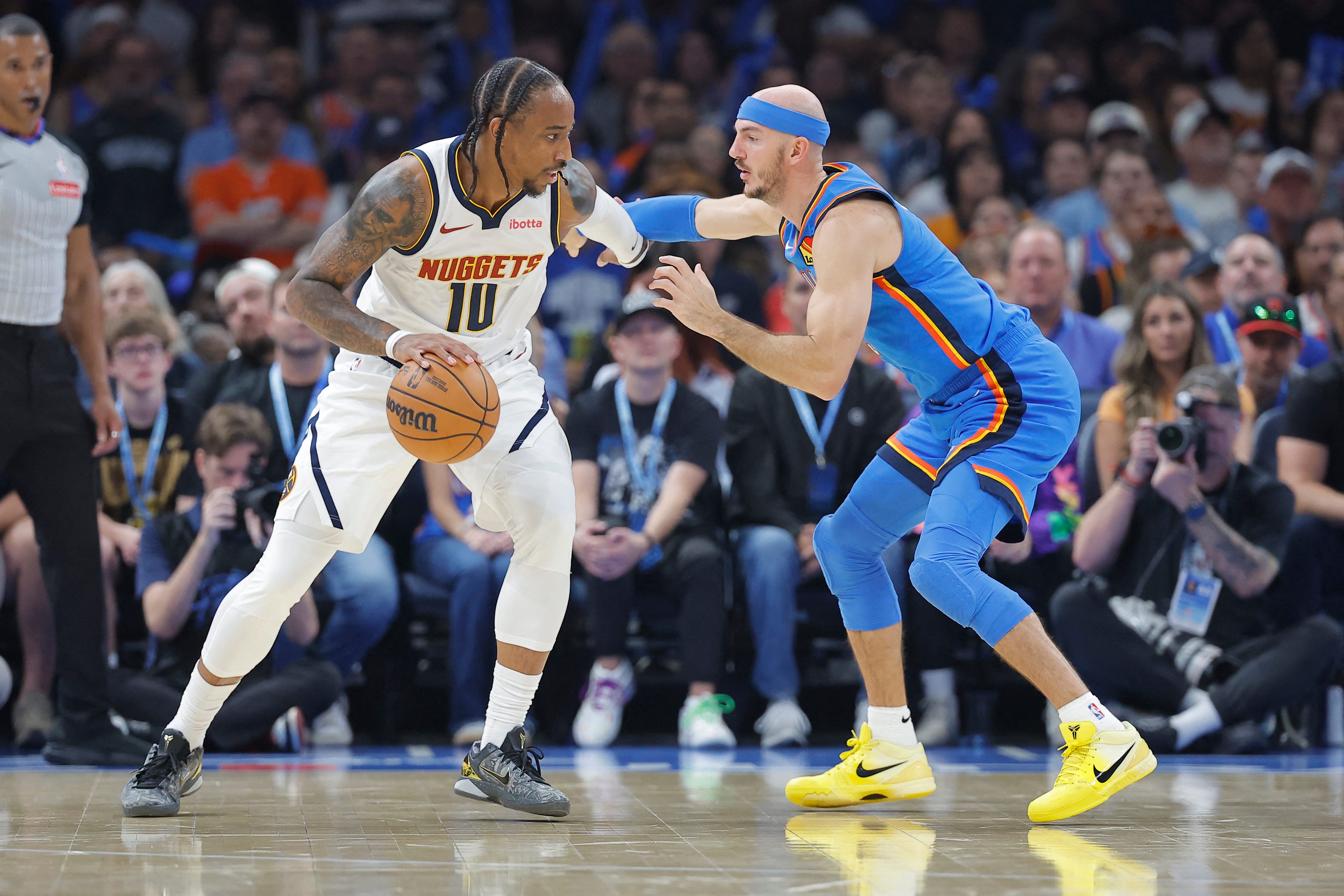 Oct 22, 2026; Oklahoma City, Oklahoma, USA; Denver Nuggets guard DeMar DeRozan (10) moves the ball as Oklahoma City Thunder guard Alex Caruso (9) defends during the first half at Paycom Center. Mandatory Credit: Alonzo Adams-Imagn Images