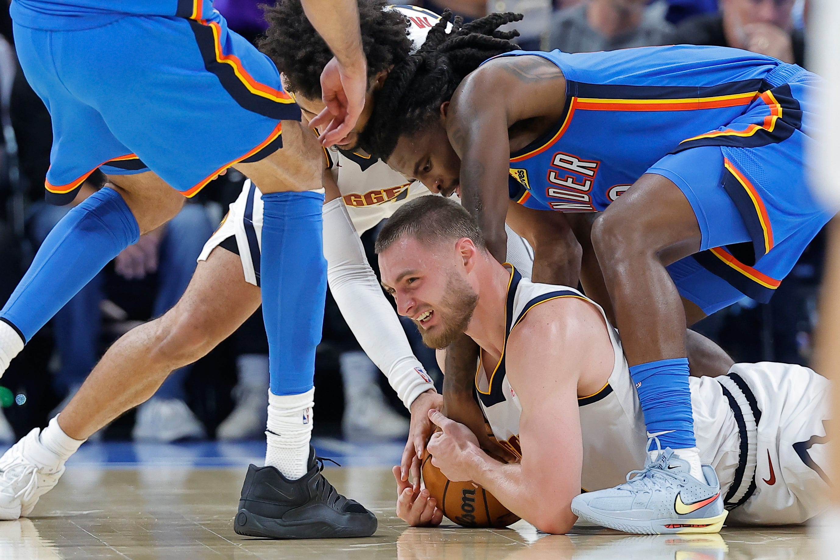 Oct 22, 2026; Oklahoma City, Oklahoma, USA; Denver Nuggets guard Christian Braun (0) and Oklahoma City Thunder guard Cason Wallace (22) fight for a loose ball during the second half at Paycom Center. Mandatory Credit: Alonzo Adams-Imagn Images