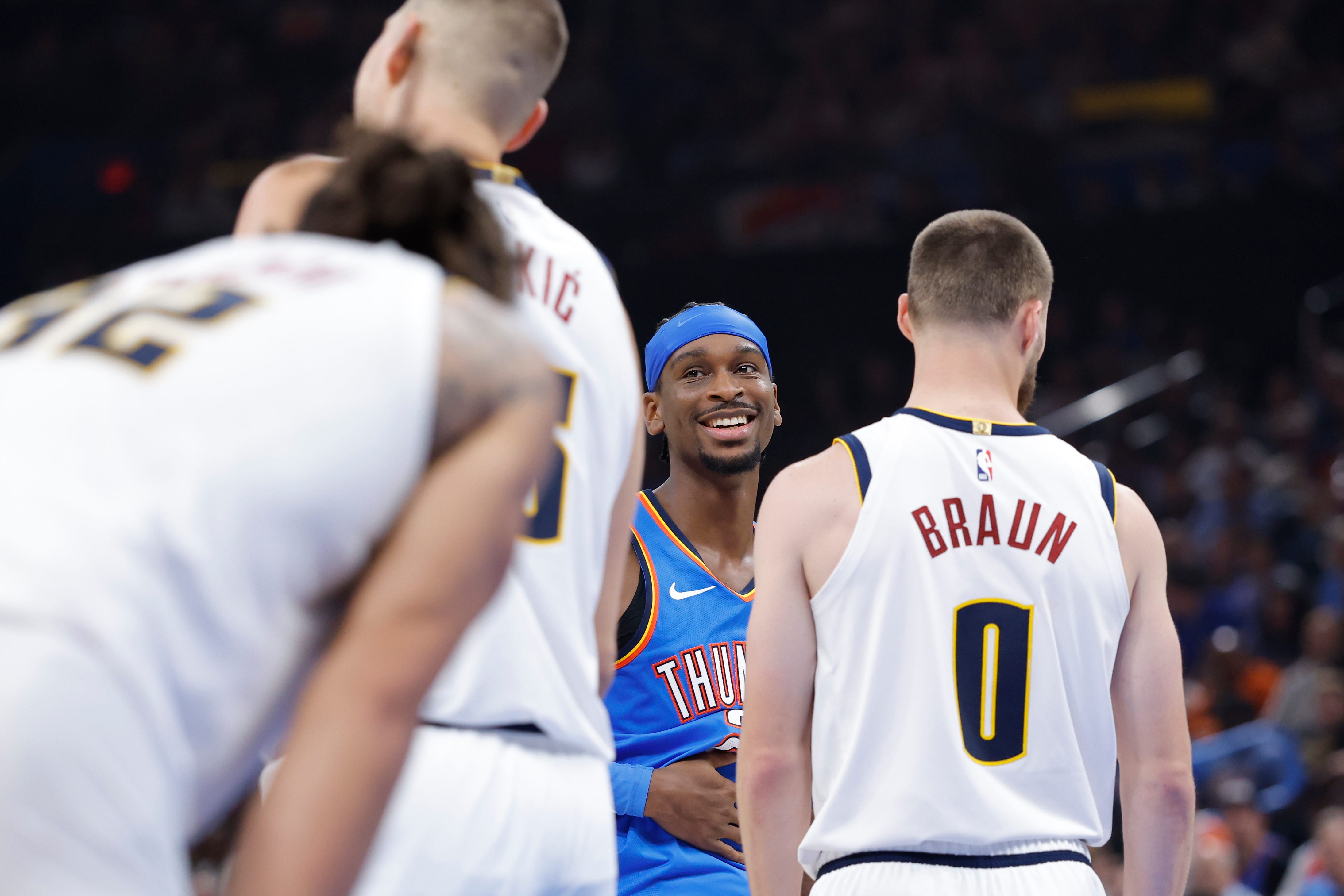 Oct 22, 2026; Oklahoma City, Oklahoma, USA; Oklahoma City Thunder guard Shai Gilgeous-Alexander (2) smiles at Denver Nuggets center Nikola Jokic (15) after a play during the first half at Paycom Center. Mandatory Credit: Alonzo Adams-Imagn Images