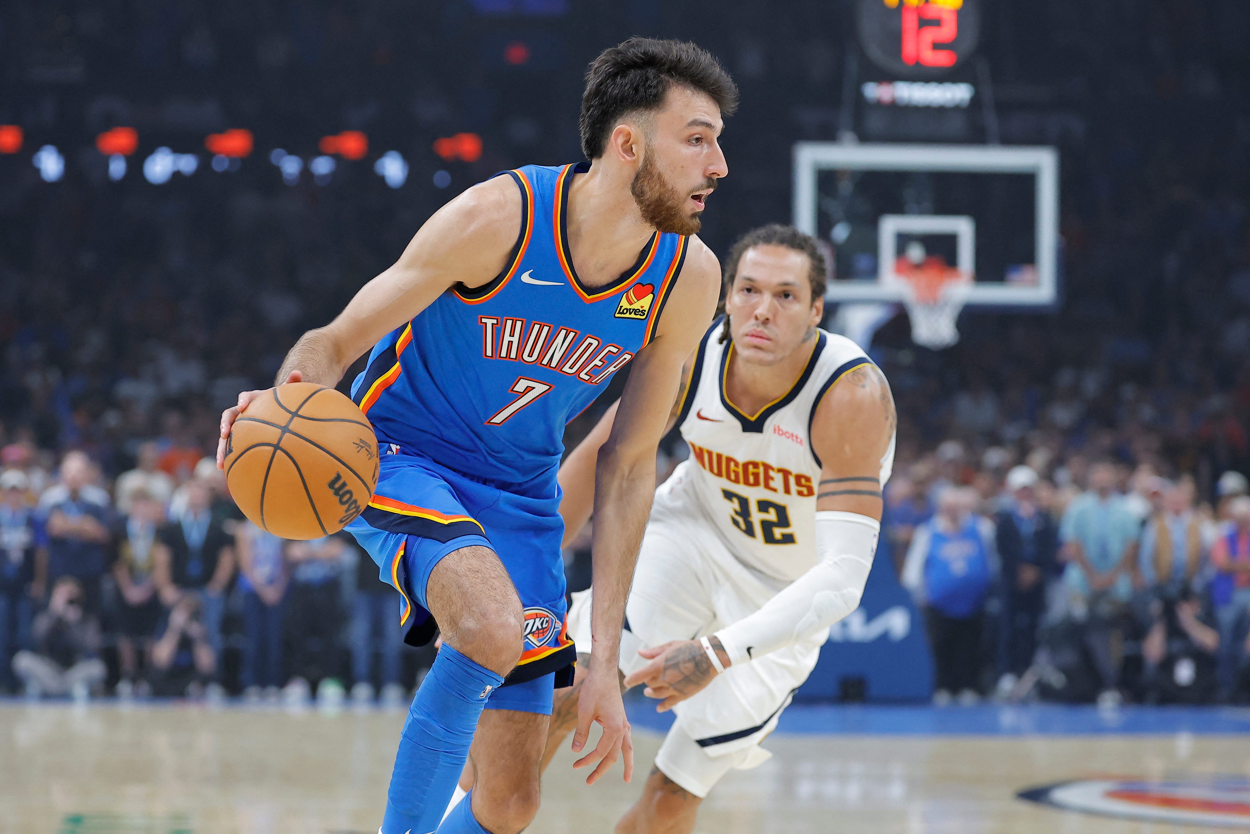 Oct 22, 2026; Oklahoma City, Oklahoma, USA; Oklahoma City Thunder center Chet Holmgren (7) drives past Denver Nuggets forward Aaron Gordon (32) during the first quarter at Paycom Center. Mandatory Credit: Alonzo Adams-Imagn Images