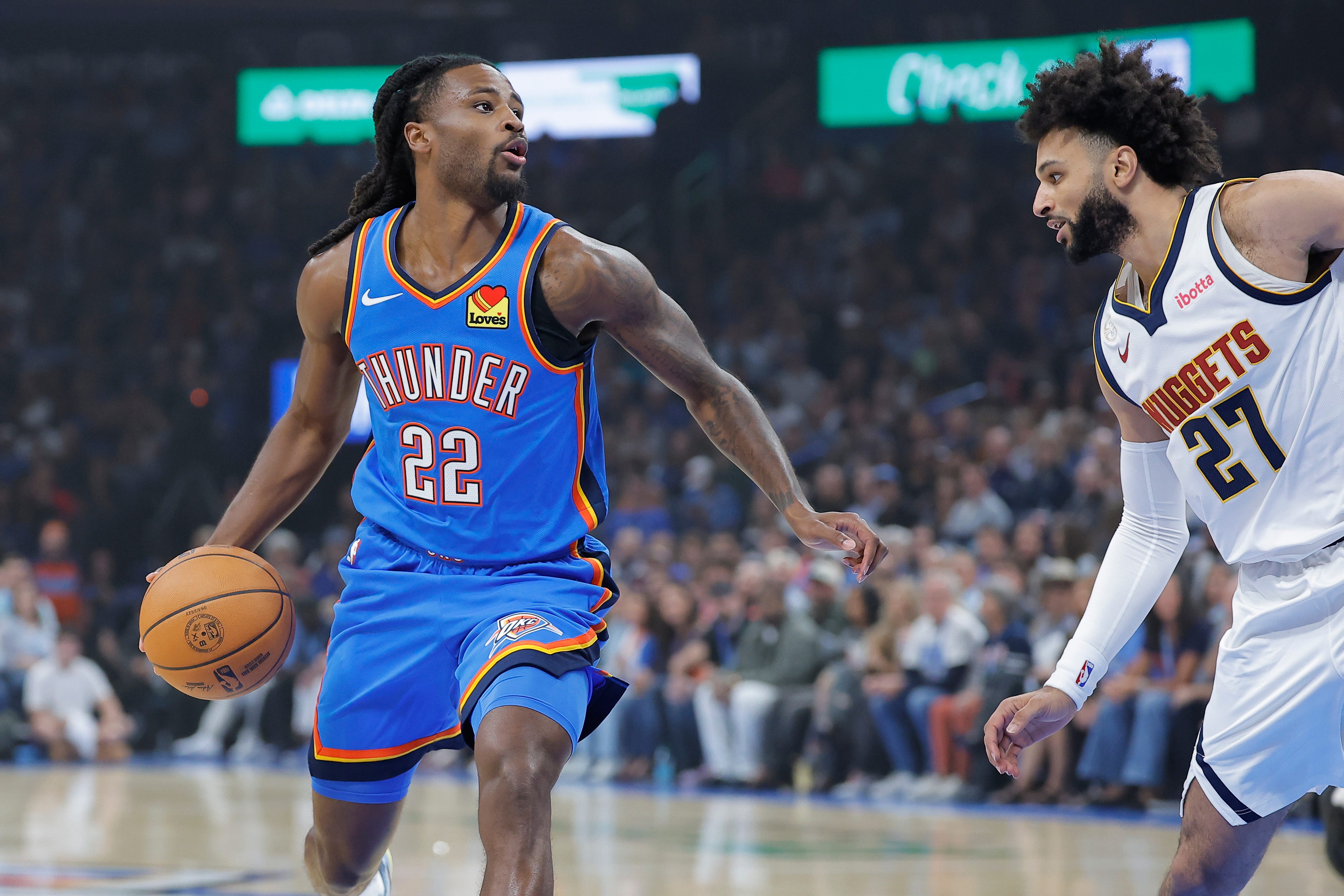 Oct 22, 2026; Oklahoma City, Oklahoma, USA; Oklahoma City Thunder guard Cason Wallace (22) drives to the basket as Denver Nuggets guard Jamal Murray (27) defends during the first quarter at Paycom Center. Mandatory Credit: Alonzo Adams-Imagn Images