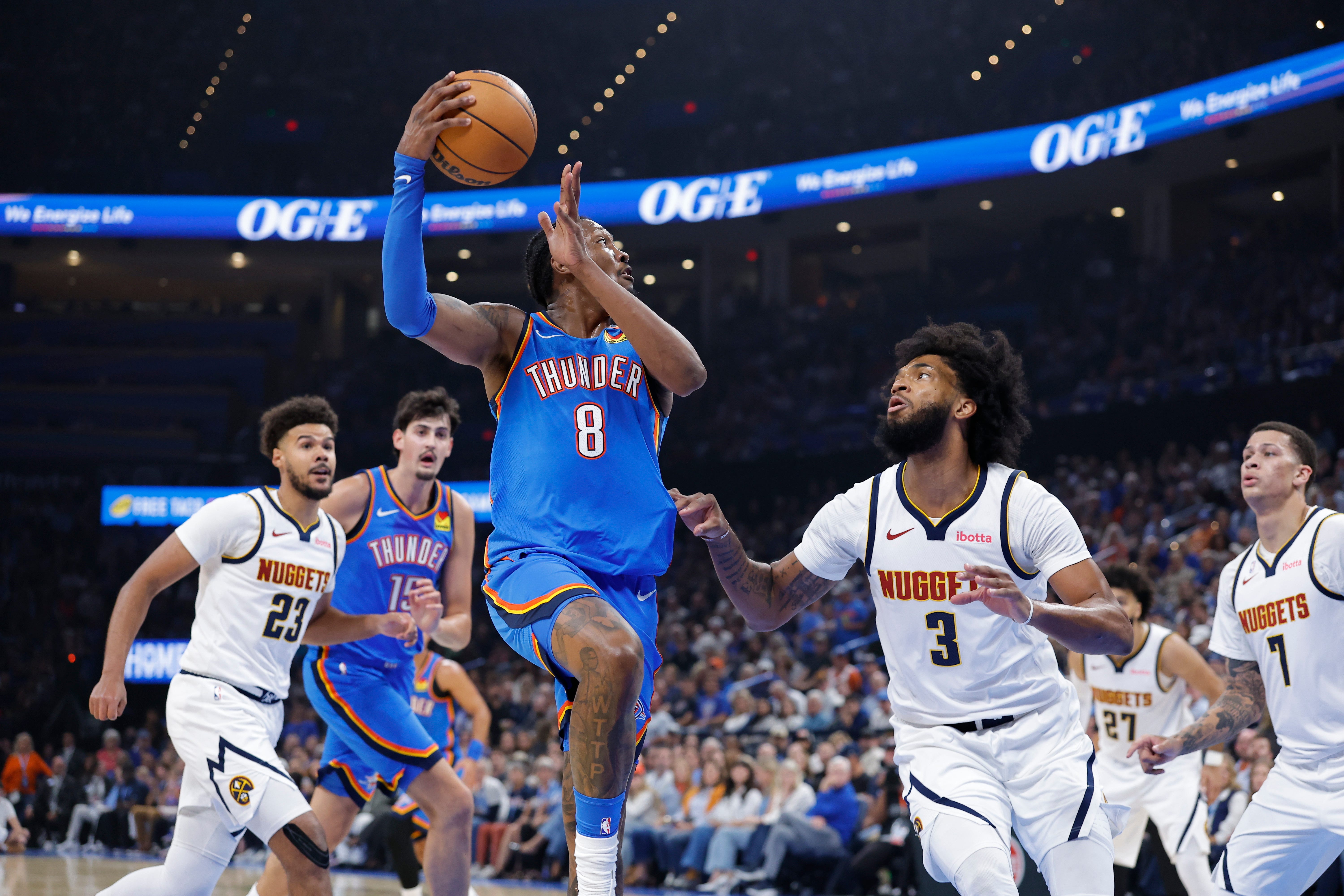 Oct 22, 2026; Oklahoma City, Oklahoma, USA; Oklahoma City Thunder guard Jalen Williams (8) goes up for a basket beside Denver Nuggets forward Marvin Bagley III (3) during the first half at Paycom Center. Mandatory Credit: Alonzo Adams-Imagn Images