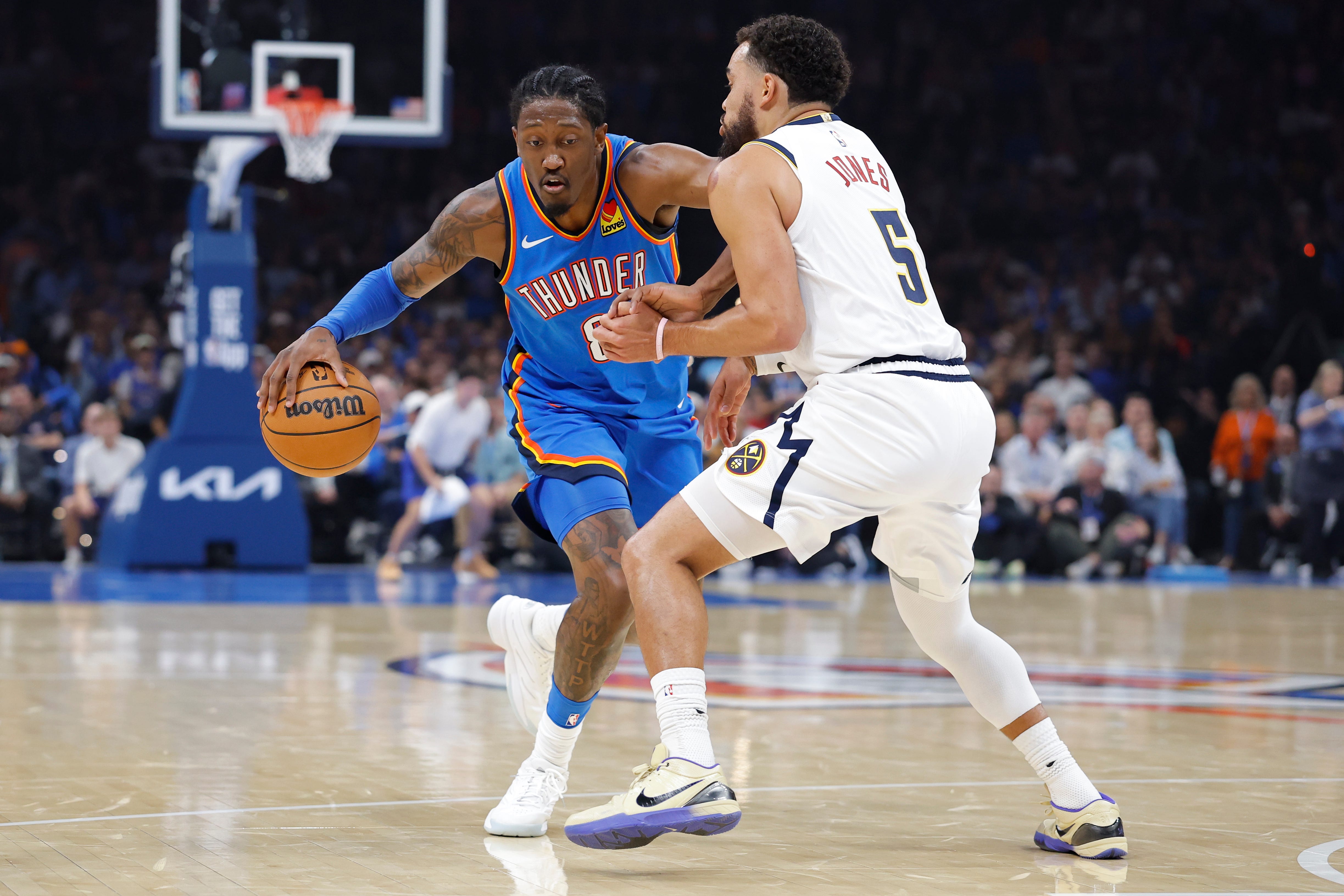Oct 22, 2026; Oklahoma City, Oklahoma, USA; Oklahoma City Thunder guard Jalen Williams (8) drives down the court as Denver Nuggets guard Tyus Jones (5) defends during the first half at Paycom Center. Mandatory Credit: Alonzo Adams-Imagn Images