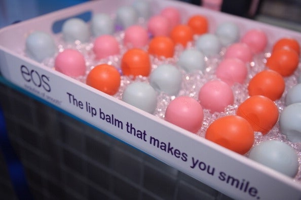 Tray of spherical shaped EOS lip balms, presented on ice, with the slogan