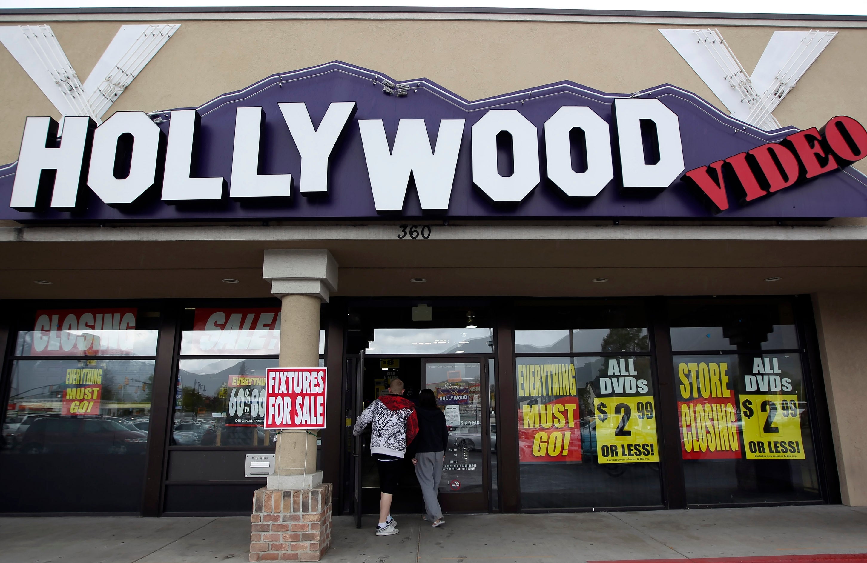 Closed Hollywood video store with permission signs in windows including