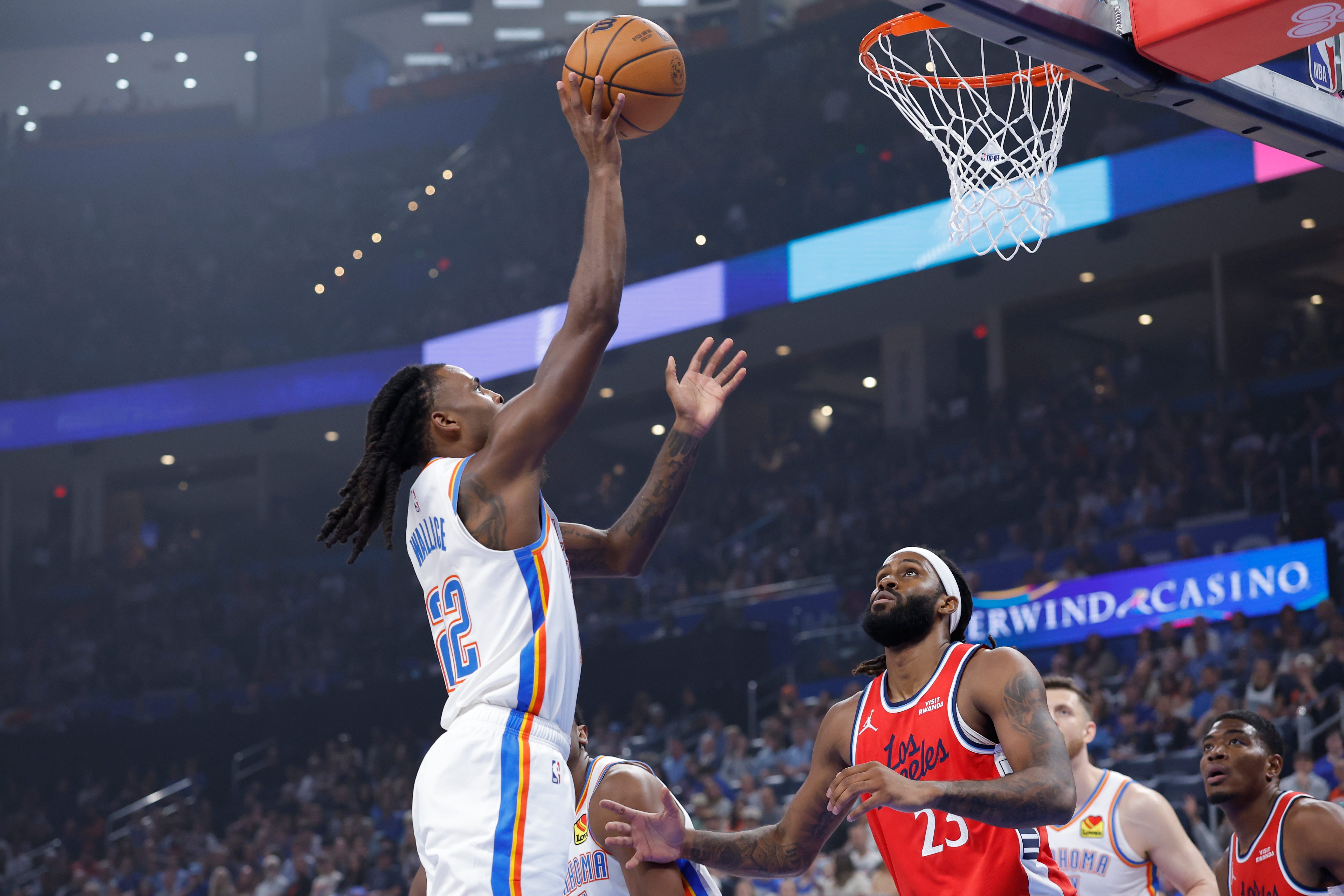 Oct 25, 2026; Oklahoma City, Oklahoma, USA; Oklahoma City Thunder guard Cason Wallace (22) shoots as Los Angeles Clippers forward Isaiah Jackson (23) looks on during the first half at Paycom Center. Mandatory Credit: Alonzo Adams-Imagn Images