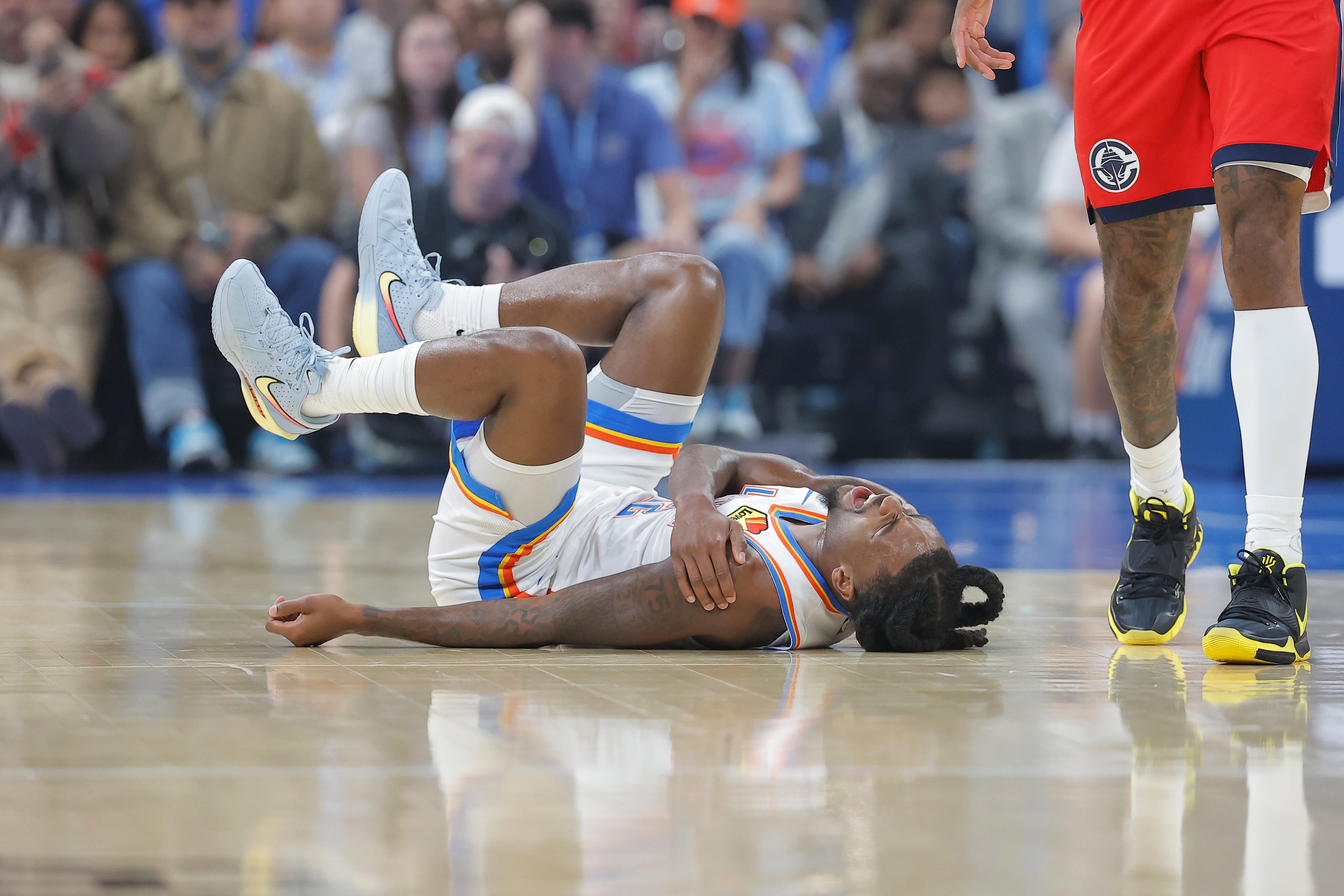 Oct 25, 2026; Oklahoma City, Oklahoma, USA; Oklahoma City Thunder guard Cason Wallace (22) falls to the floor holding his shoulder during a play against the Los Angeles Clippers during the first half at Paycom Center. Mandatory Credit: Alonzo Adams-Imagn Images