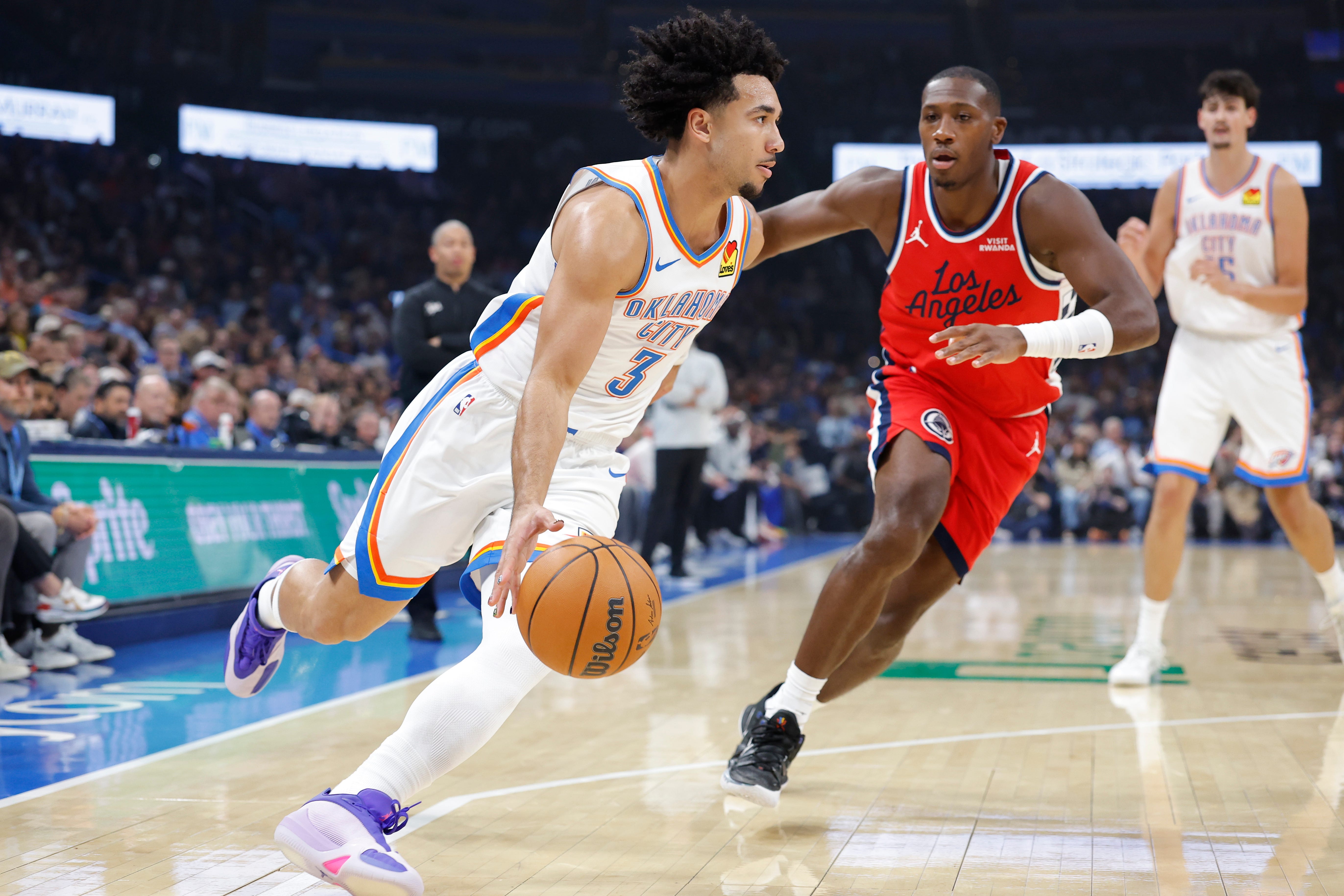 Oct 25, 2026; Oklahoma City, Oklahoma, USA; Oklahoma City Thunder guard Jared McCain (3) drives around Los Angeles Clippers guard Kris Dunn (8) during the first half at Paycom Center. Mandatory Credit: Alonzo Adams-Imagn Images