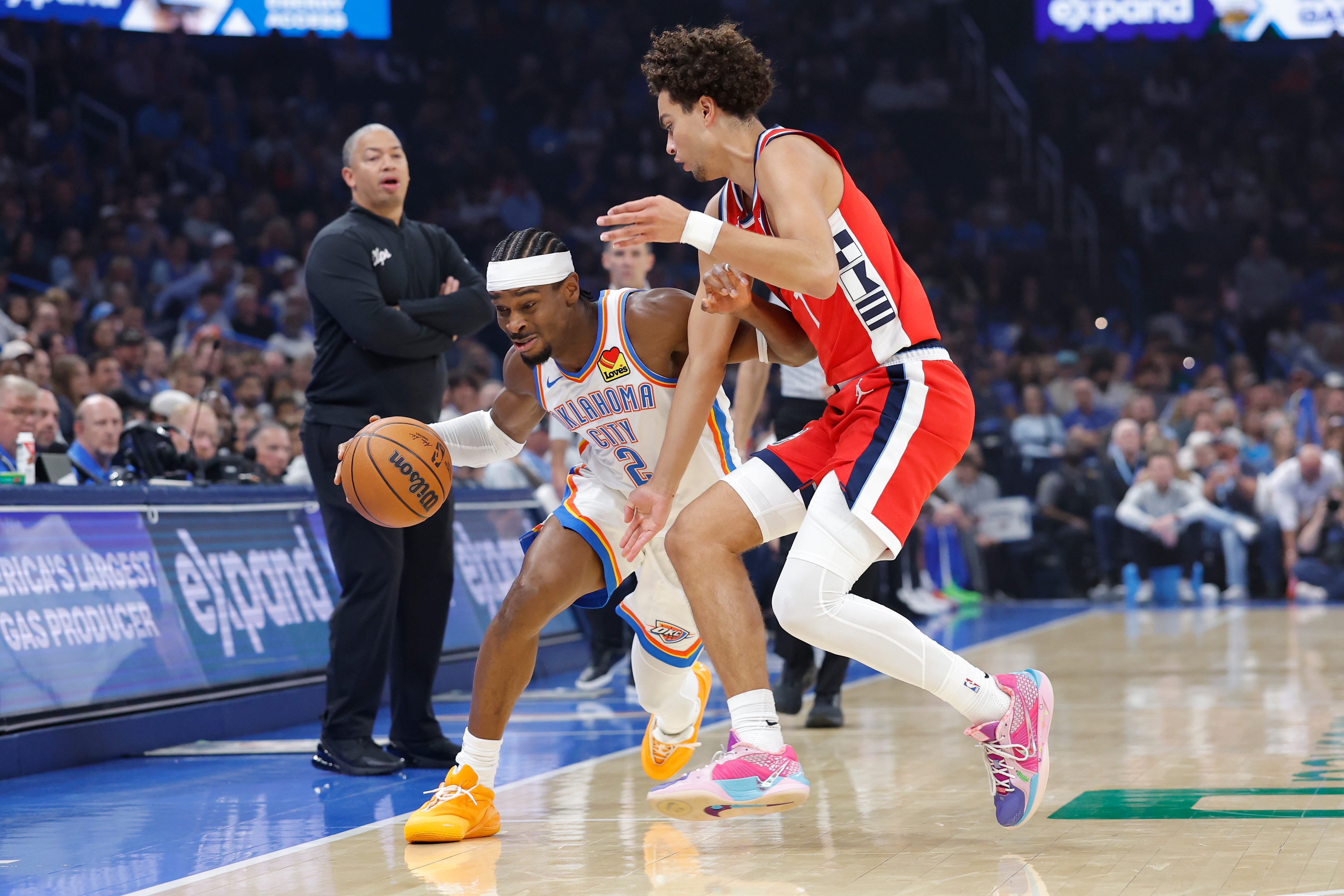 Oct 25, 2026; Oklahoma City, Oklahoma, USA; Oklahoma City Thunder guard Shai Gilgeous-Alexander (2) drives around Los Angeles Clippers guard Kobe Sanders (4) during the first half at Paycom Center. Mandatory Credit: Alonzo Adams-Imagn Images