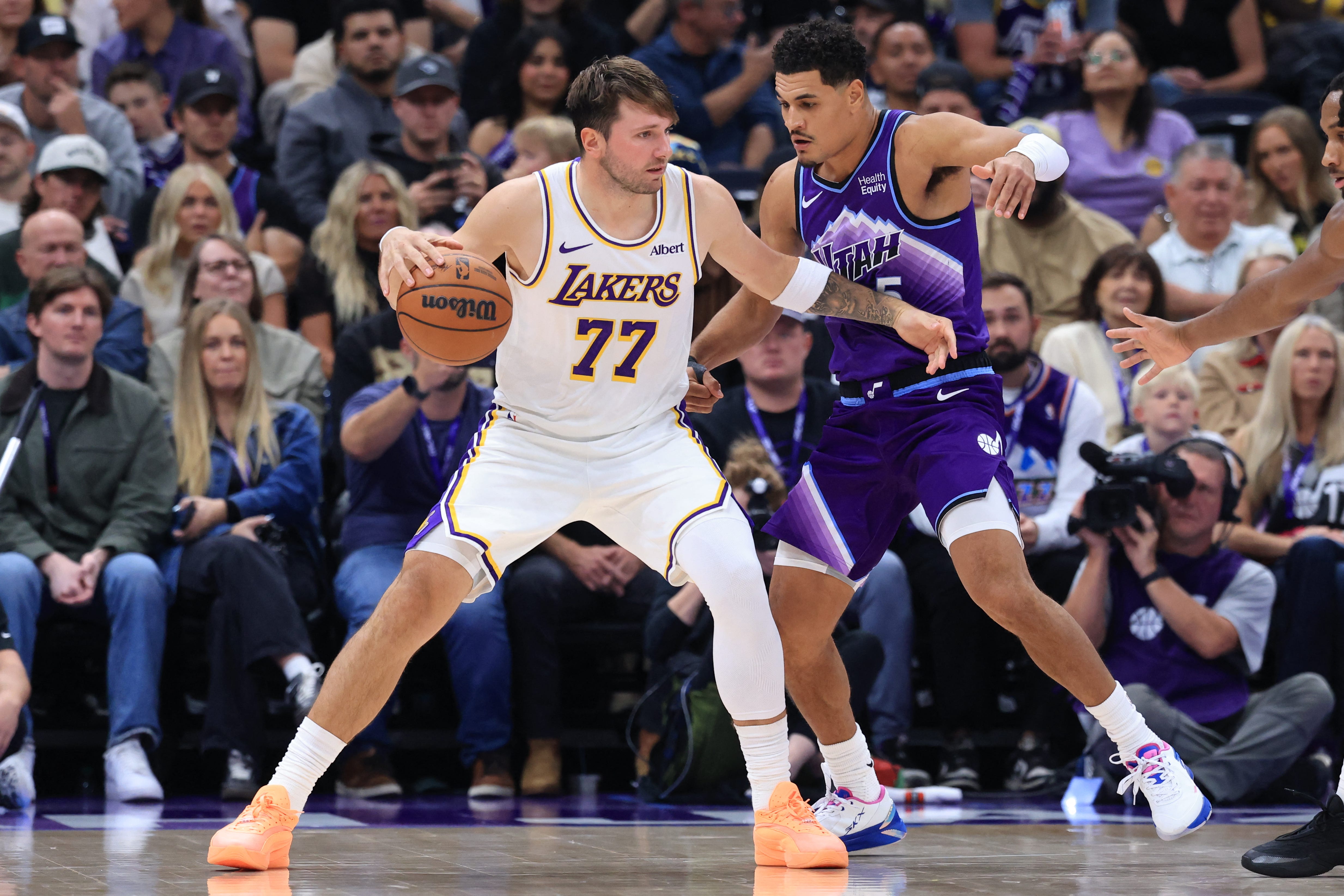 Oct 25, 2026; Salt Lake City, Utah, USA;  Los Angeles Lakers guard Luka Doncic (77) posts up against Utah Jazz guard Josh Green (5) during the second half at Delta Center.  Mandatory Credit: Rob Gray-Imagn Images