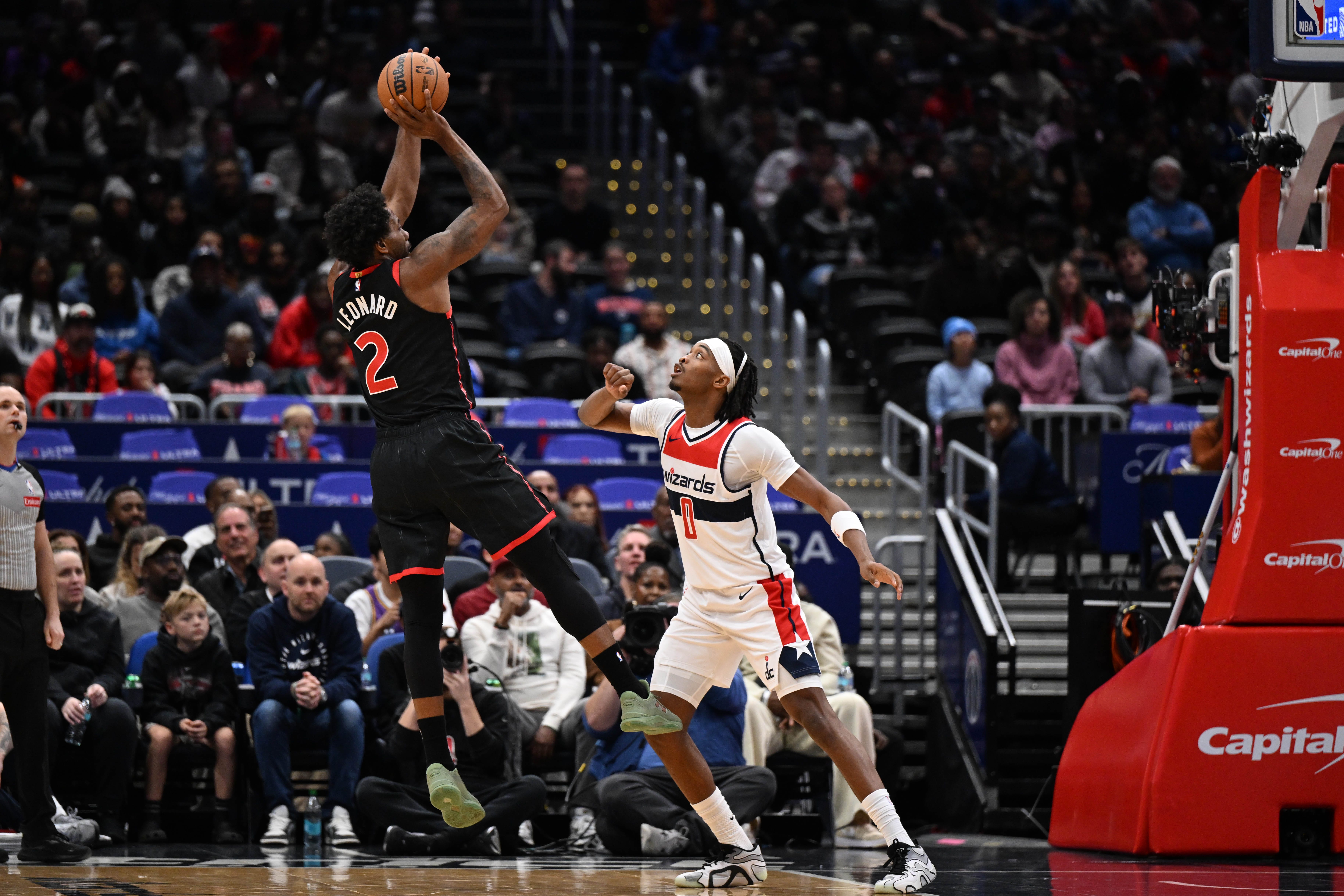 Oct 23, 2026; Washington, District of Columbia, USA; Toronto Raptors forward Kawhi Leonard (2) shoots over Washington Wizards guard Bilal Coulibaly (0) during the first half at Capital One Arena. Mandatory Credit: Brad Mills-Imagn Images