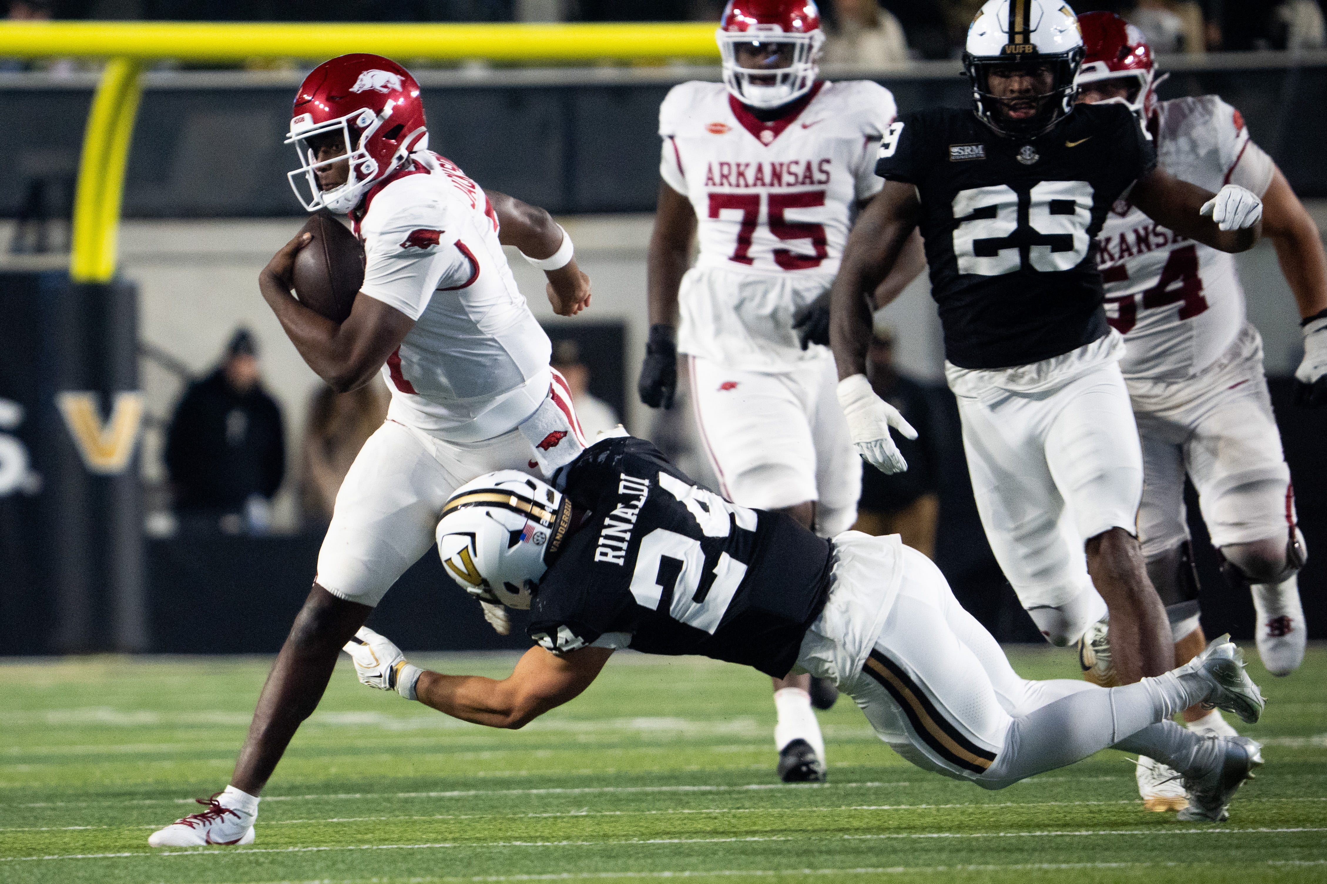 Arkansas Razorbacks quarterback KJ Jackson (7) runs the ball while Vanderbilt Commodores defensive lineman Nick Rinaldi (24) attempts a tackle during the game between Vanderbilt and Arkansas at FirstBank Stadium in Nashville on Saturday, Oct. 17, 2026.