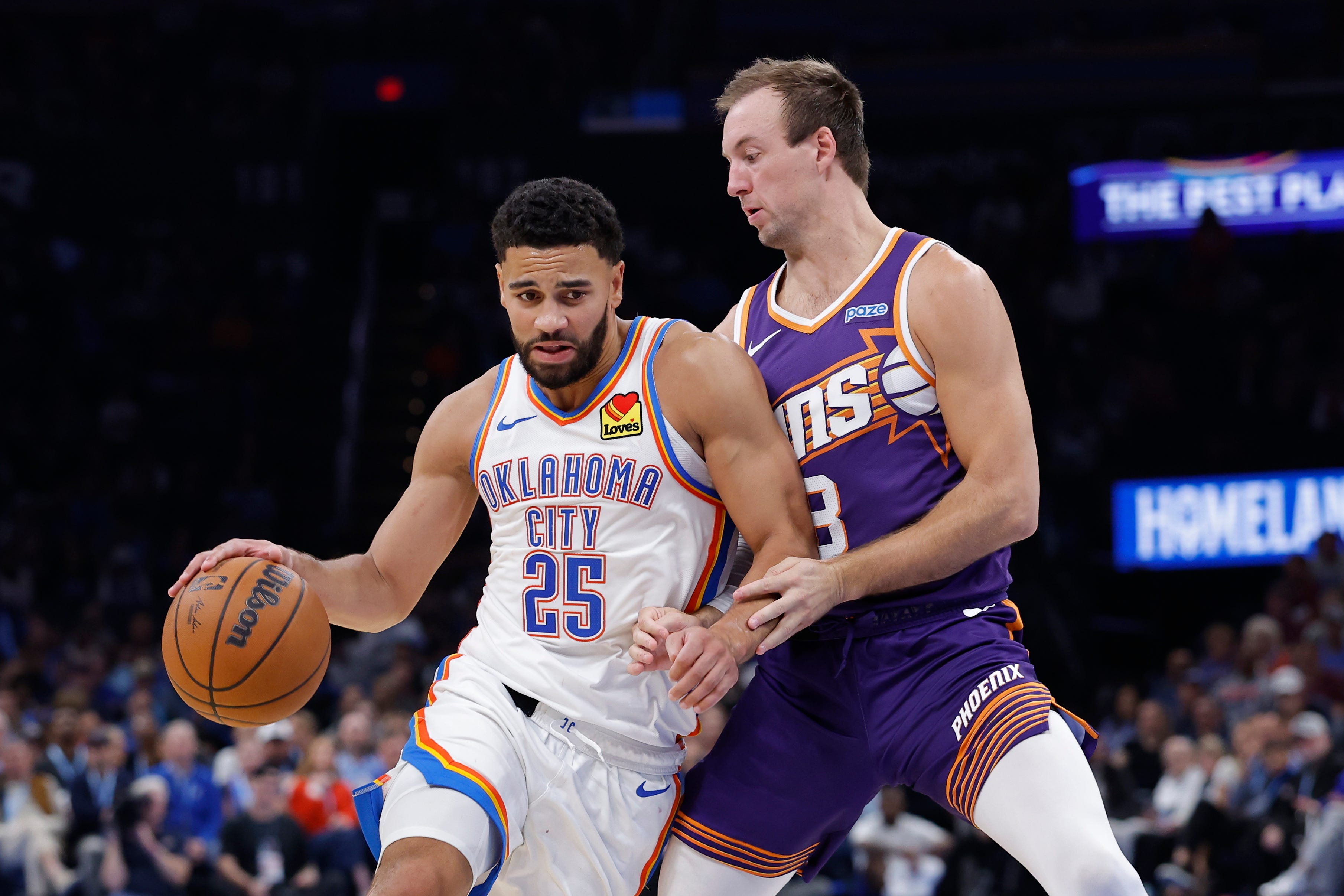 Oct 26, 2026; Oklahoma City, Oklahoma, USA; Oklahoma City Thunder guard Ajay Mitchell (25) moves the ball around Phoenix Suns guard Luke Kennard (8) during the second half at Paycom Center. Mandatory Credit: Alonzo Adams-Imagn Images