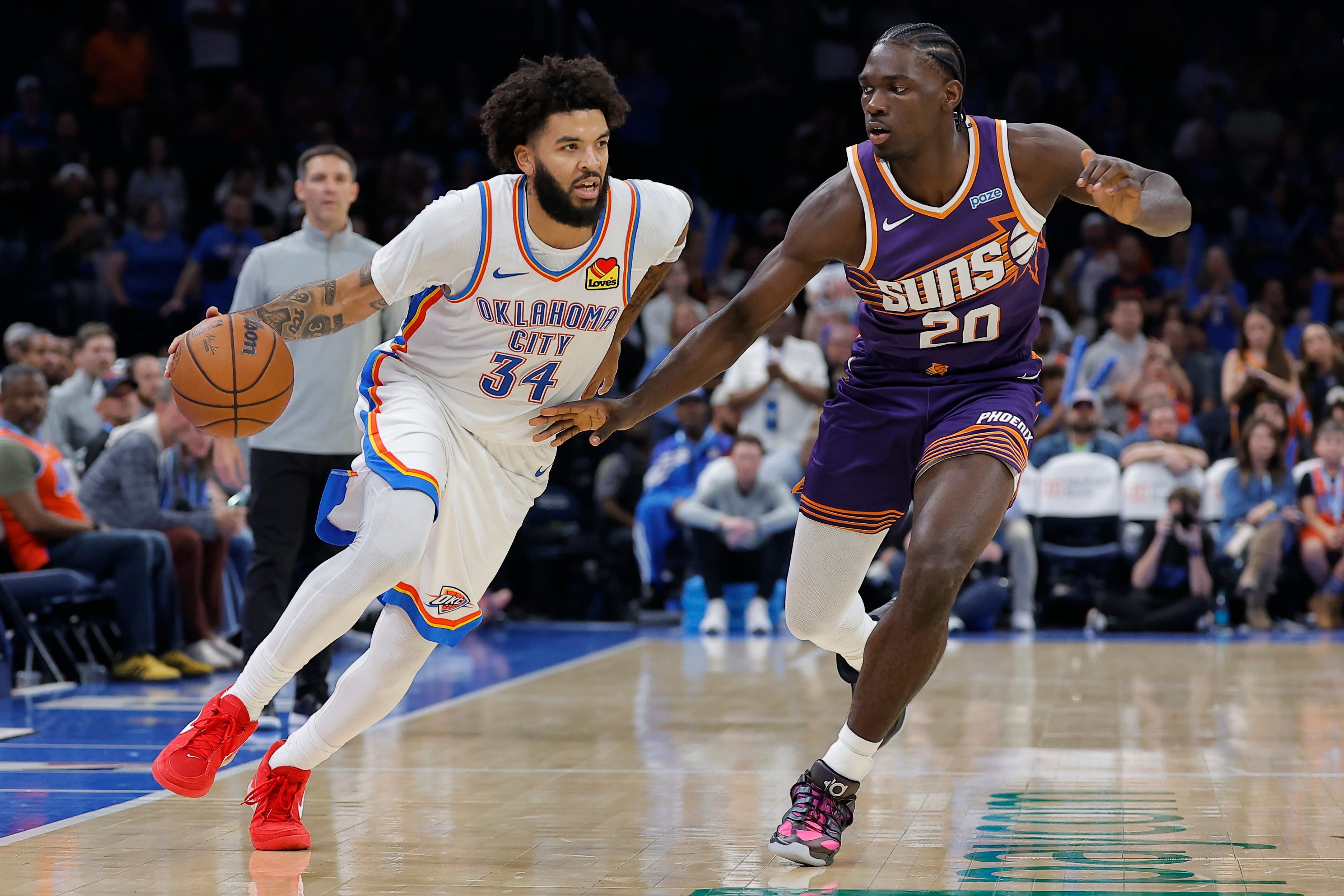 Oct 26, 2026; Oklahoma City, Oklahoma, USA; Oklahoma City Thunder guard Kenrich Williams (34) drives down the court beside Phoenix Suns forward Rasheer Fleming (20) during the second half at Paycom Center. Mandatory Credit: Alonzo Adams-Imagn Images