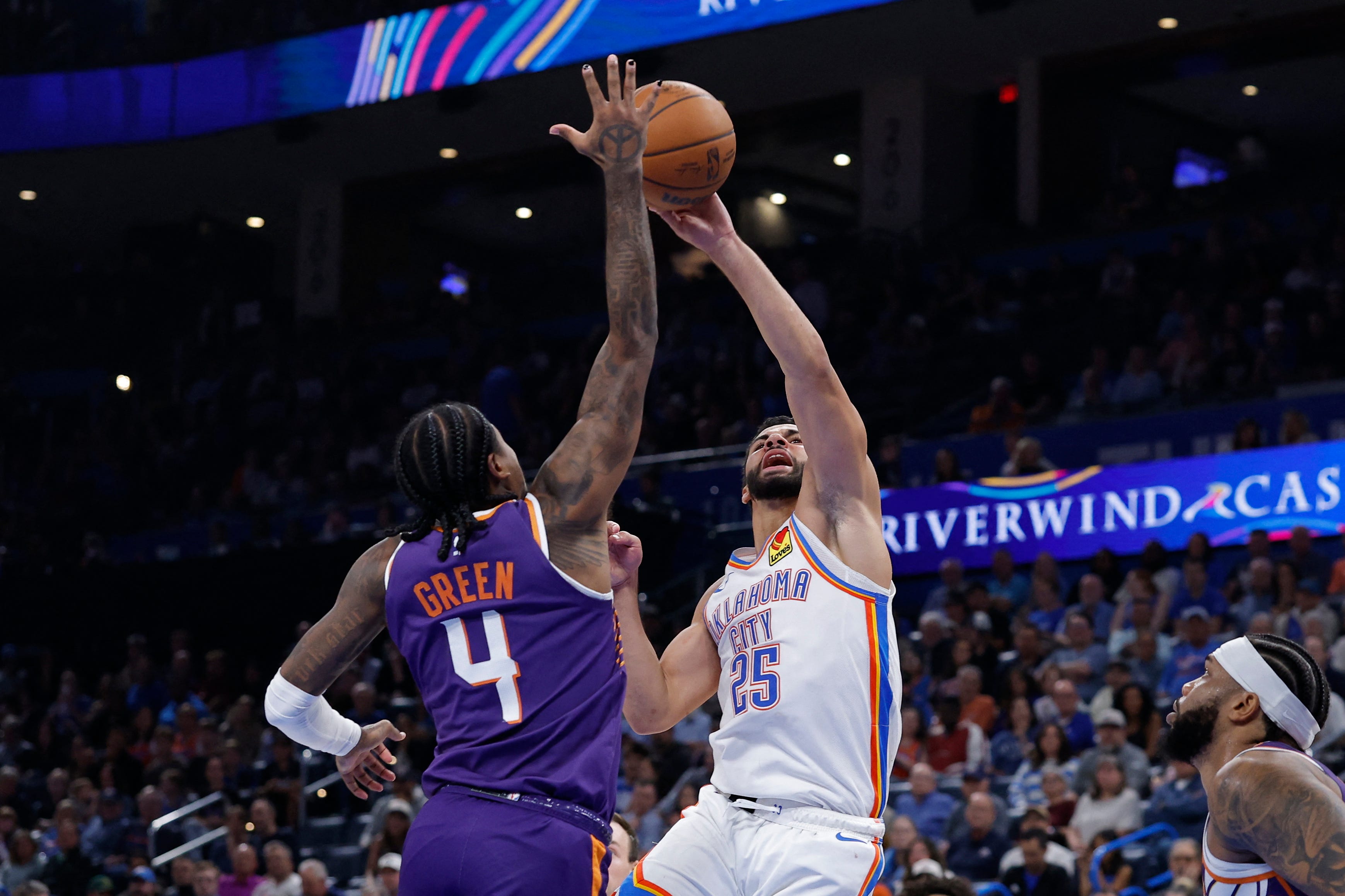 Oct 26, 2026; Oklahoma City, Oklahoma, USA; Oklahoma City Thunder guard Ajay Mitchell (25) shoots as Phoenix Suns guard Jalen Green (4) defends during the second half at Paycom Center. Mandatory Credit: Alonzo Adams-Imagn Images