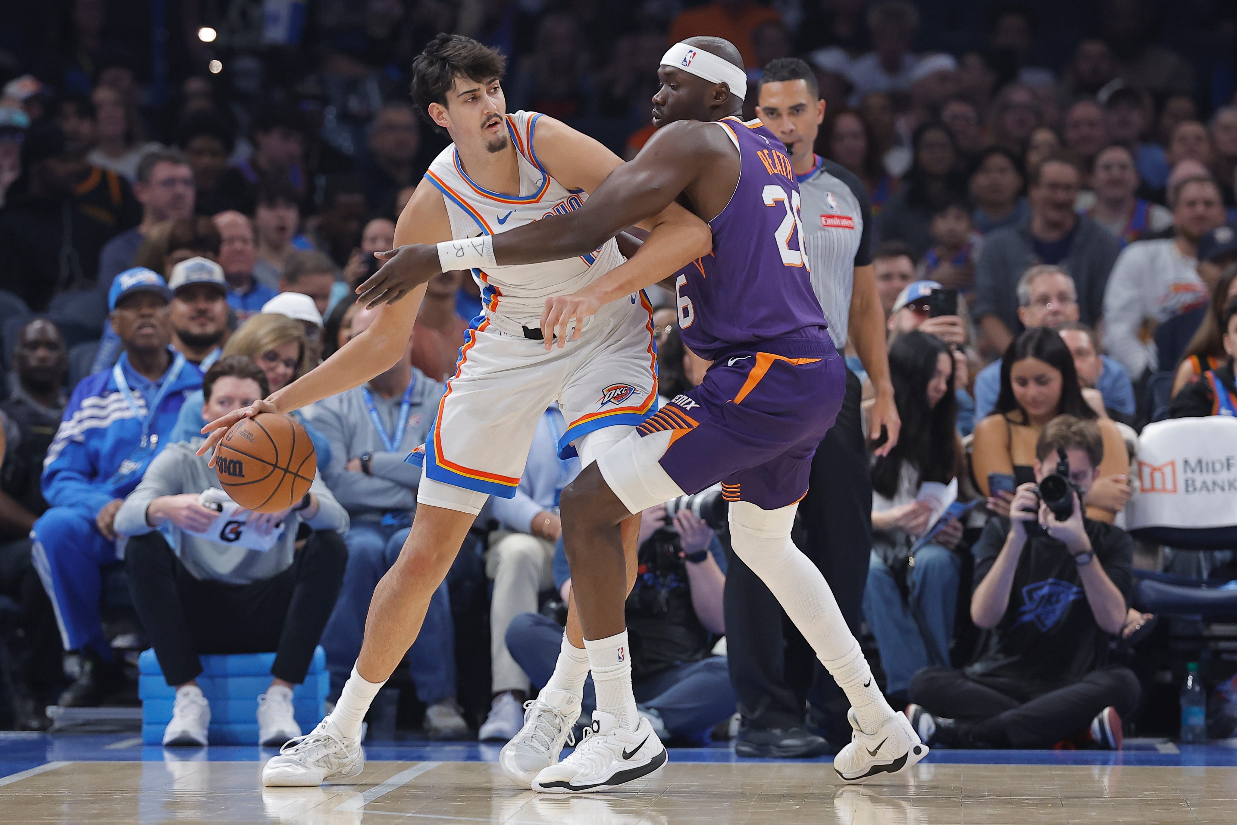 Oct 26, 2026; Oklahoma City, Oklahoma, USA; Oklahoma City Thunder center Aday Mara (15) moves the ball as Phoenix Suns center Duop Reath (26) defends during the first half at Paycom Center. Mandatory Credit: Alonzo Adams-Imagn Images