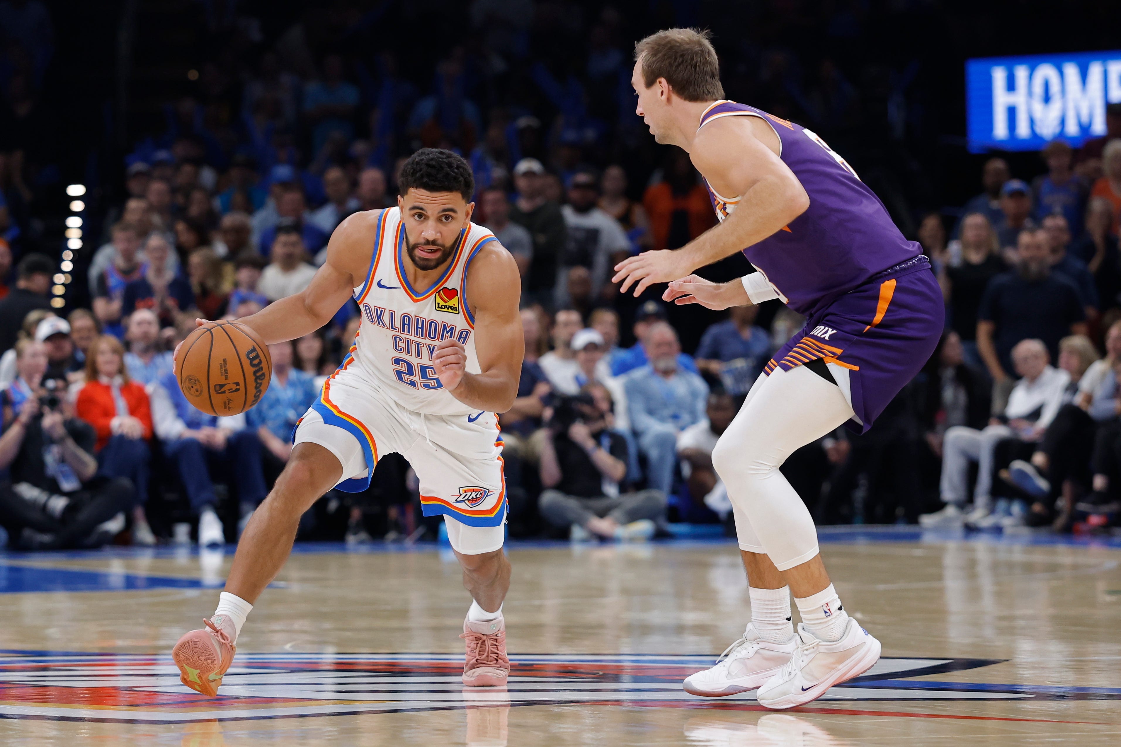 Oct 26, 2026; Oklahoma City, Oklahoma, USA; Oklahoma City Thunder guard Ajay Mitchell (25) drives past Phoenix Suns guard Luke Kennard (8) during the second half at Paycom Center. Mandatory Credit: Alonzo Adams-Imagn Images