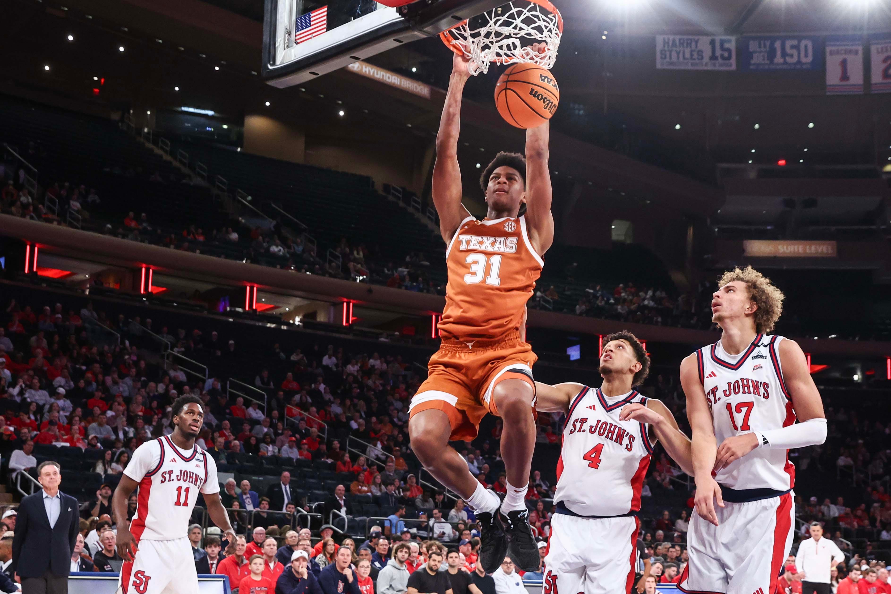 Oct 25, 2026; New York, NY, USA;  Texas Longhorns forward Marcus Spears Jr. (31) dunks past St. John's Red Storm guard Quinn Ellis (4) and forward Ruben Prey (17) in the first half at Madison Square Garden. Mandatory Credit: Wendell Cruz-Imagn Images