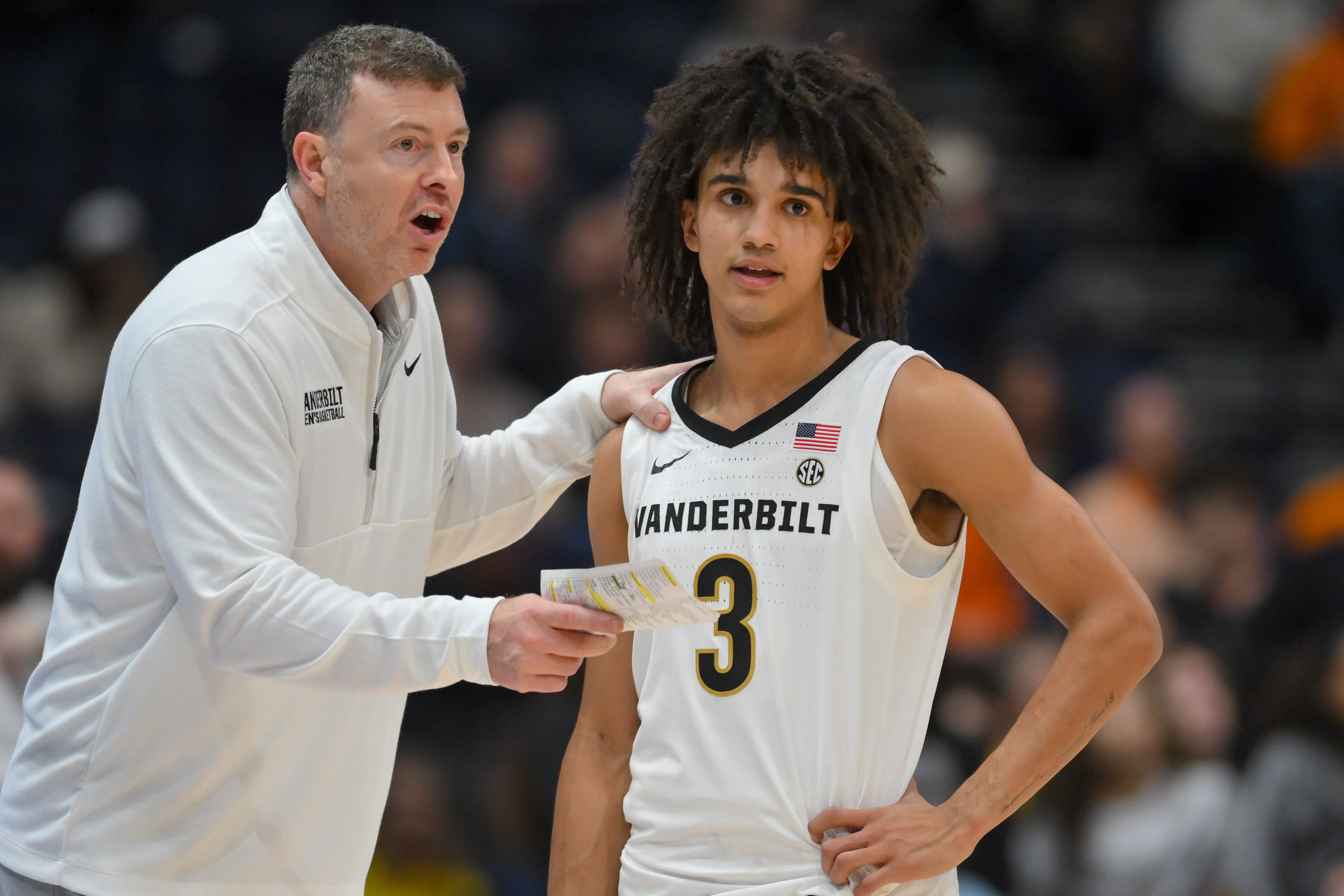 Mar 13, 2026; Nashville, TN, USA; Vanderbilt Commodores head coach Mark Byington talks with guard Tyler Tanner (3) during a break in action against the Tennessee Volunteers  during the second half at Bridgestone Arena. Mandatory Credit: Steve Roberts-Imagn Images